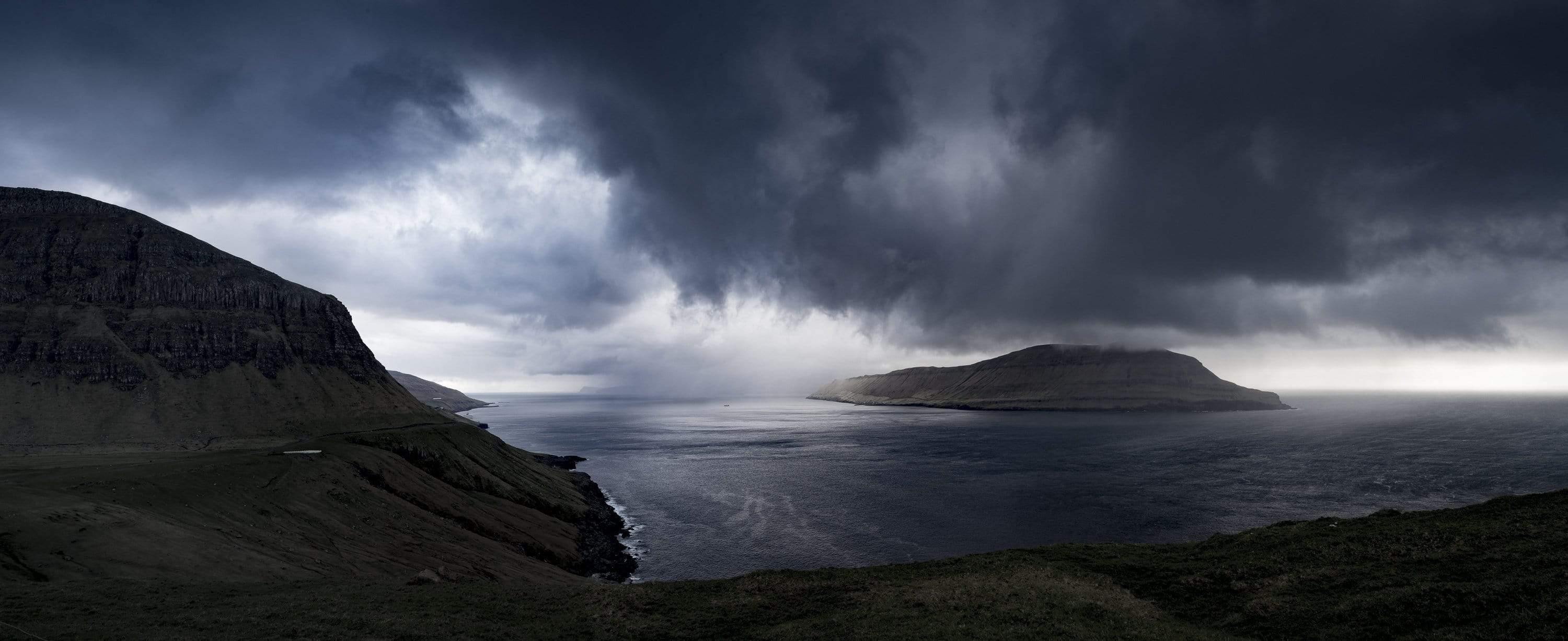 Giant black clouds are ready to fall heavily exactly on the mount of the Atlantic ocean, Atlantic Storm, Faroe Islands
