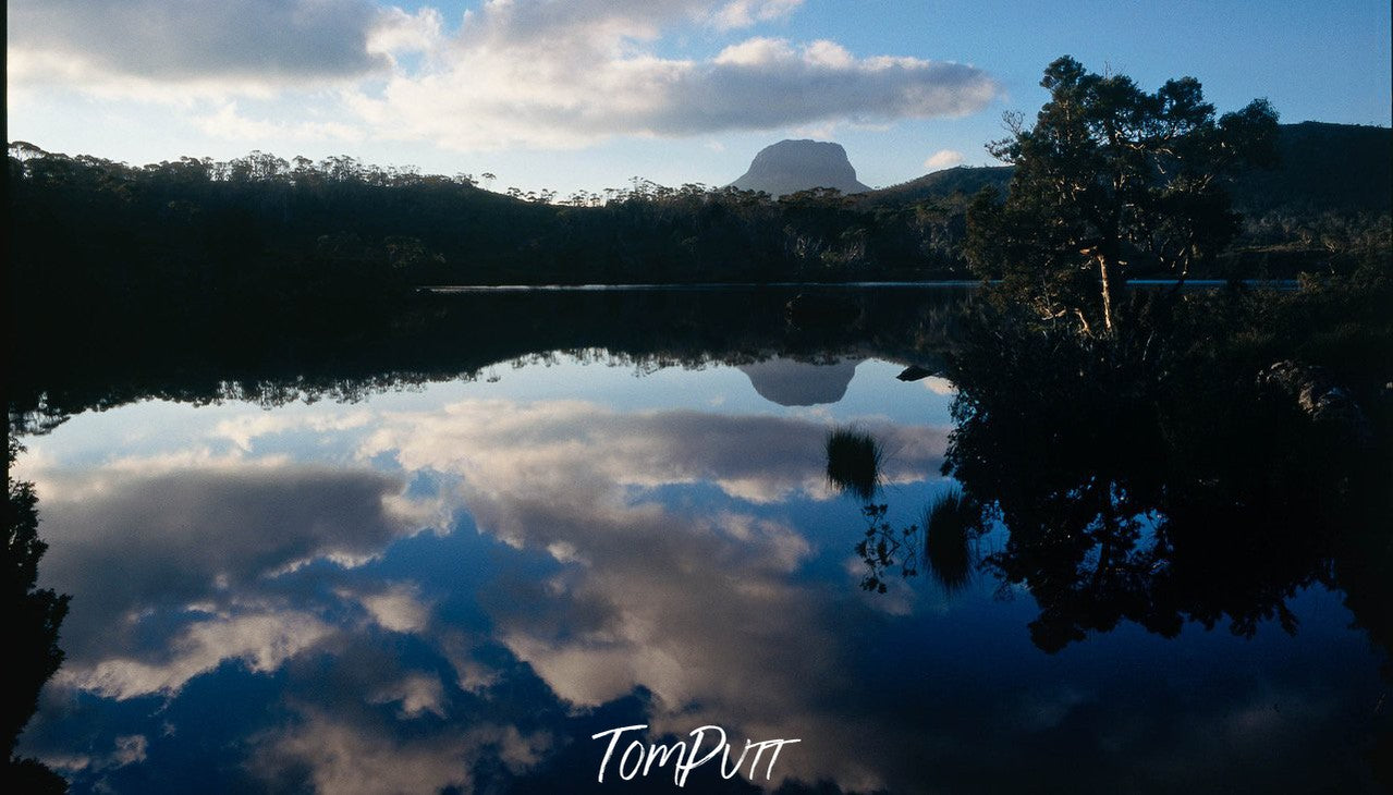 A lake surrounded by dark mountain walls, a reflection of sky in the water, Cradle Mountain #30, Tasmania