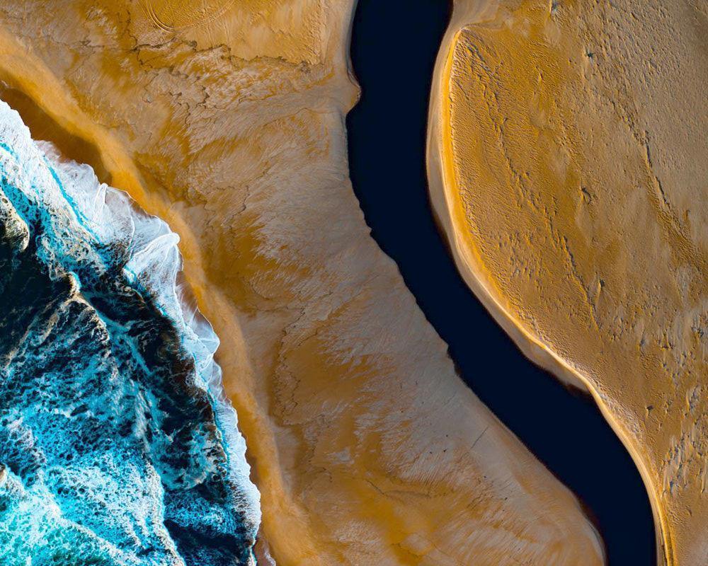Giant sand-like land with some mustard powder-like sand and a seashore connecting with it with clean and huge bubbling waves, Barricade