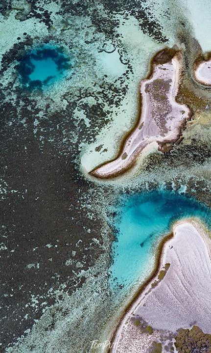 A view of an oceanic artwork with some powder-color sand-like substance and a combination of oceanic-blue and sea-green making a cold atmosphere of a sea, Blue Holes Houtman Abrolhos Art