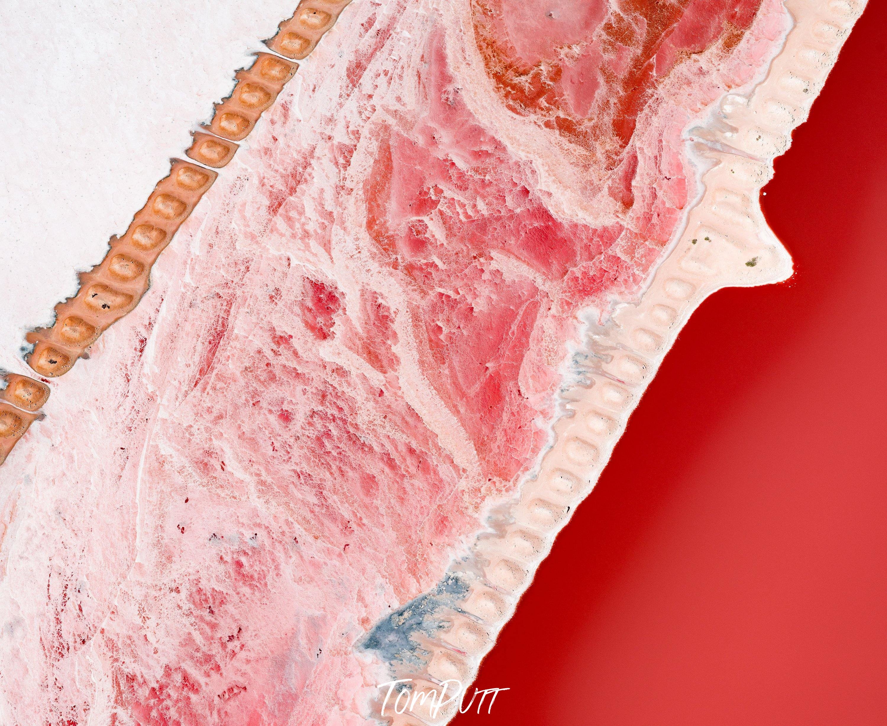 Artwork of an unknown shape, lite red-colored powder-like sand, and a dark red area at the right bottom, Creamy Soda