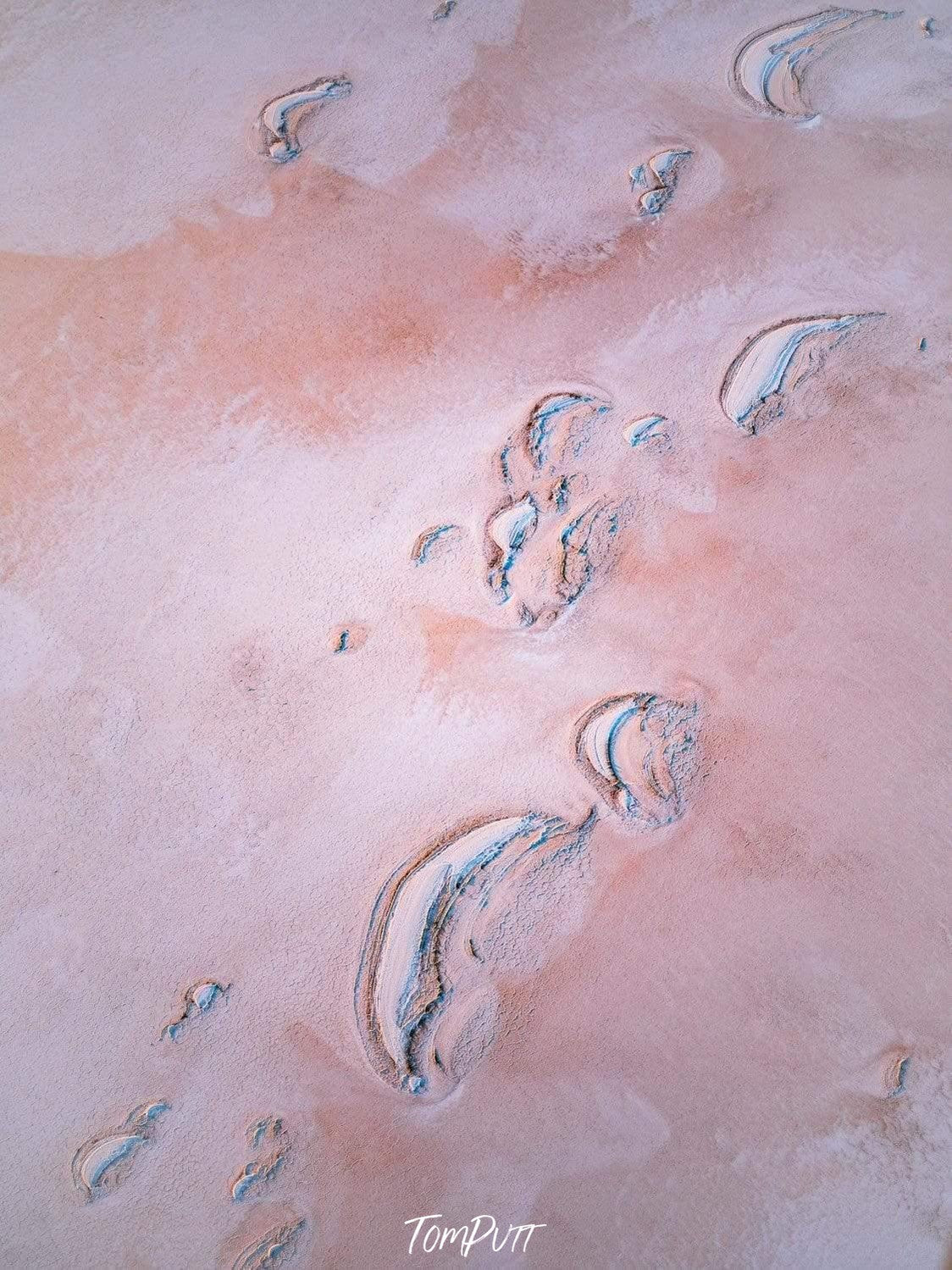 Artwork of an unknown shape, sand-colored ground, and some moon different shapes of the moon, Cresent Moons