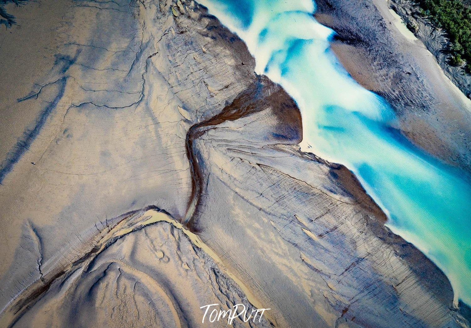A large stone land texture with a giant curved line and a vertical flow of clear ice blue water, Derby #5