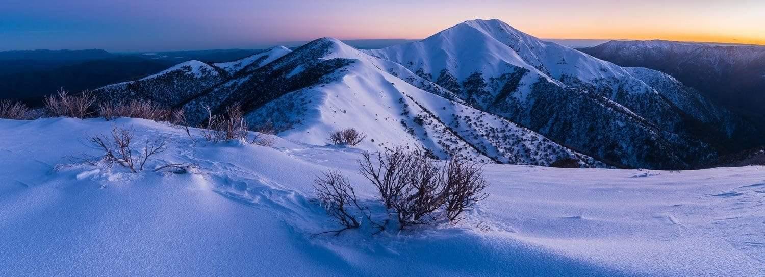A giant couple of mountains covered with snow from the top, and a land covered fully with the snow in the foreground, Feathertop Awakens - Victorian High Country