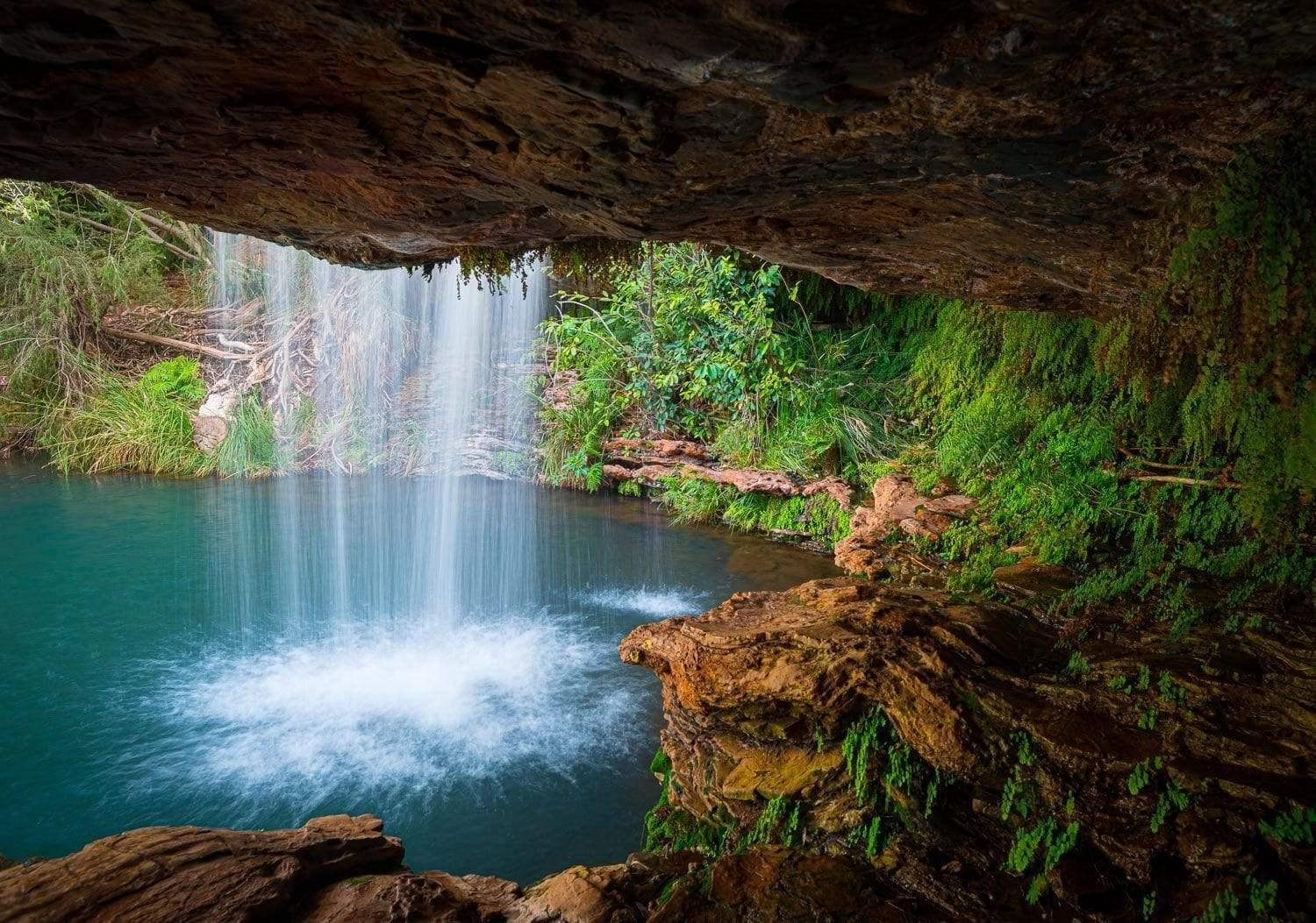 A small mountain wall with a waterfall, and a lot of greenery in surroundings, Fern Pool - Karijini, The Pilbara