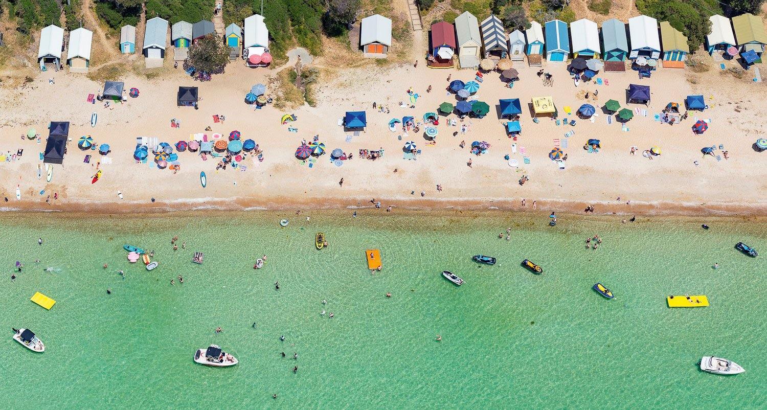 Aerial view of an ocean with many people on the beach and in water, Floating - Mornington Peninsula VIC