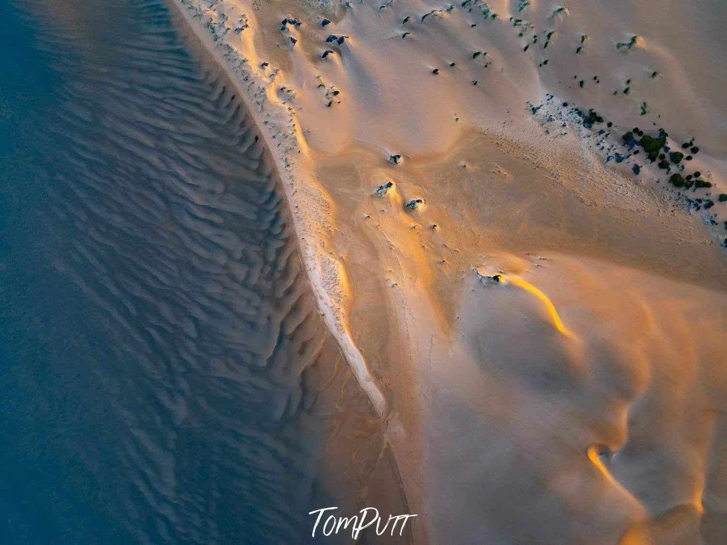 Aerial view of a dark beach with some golden light effect, Golden Light