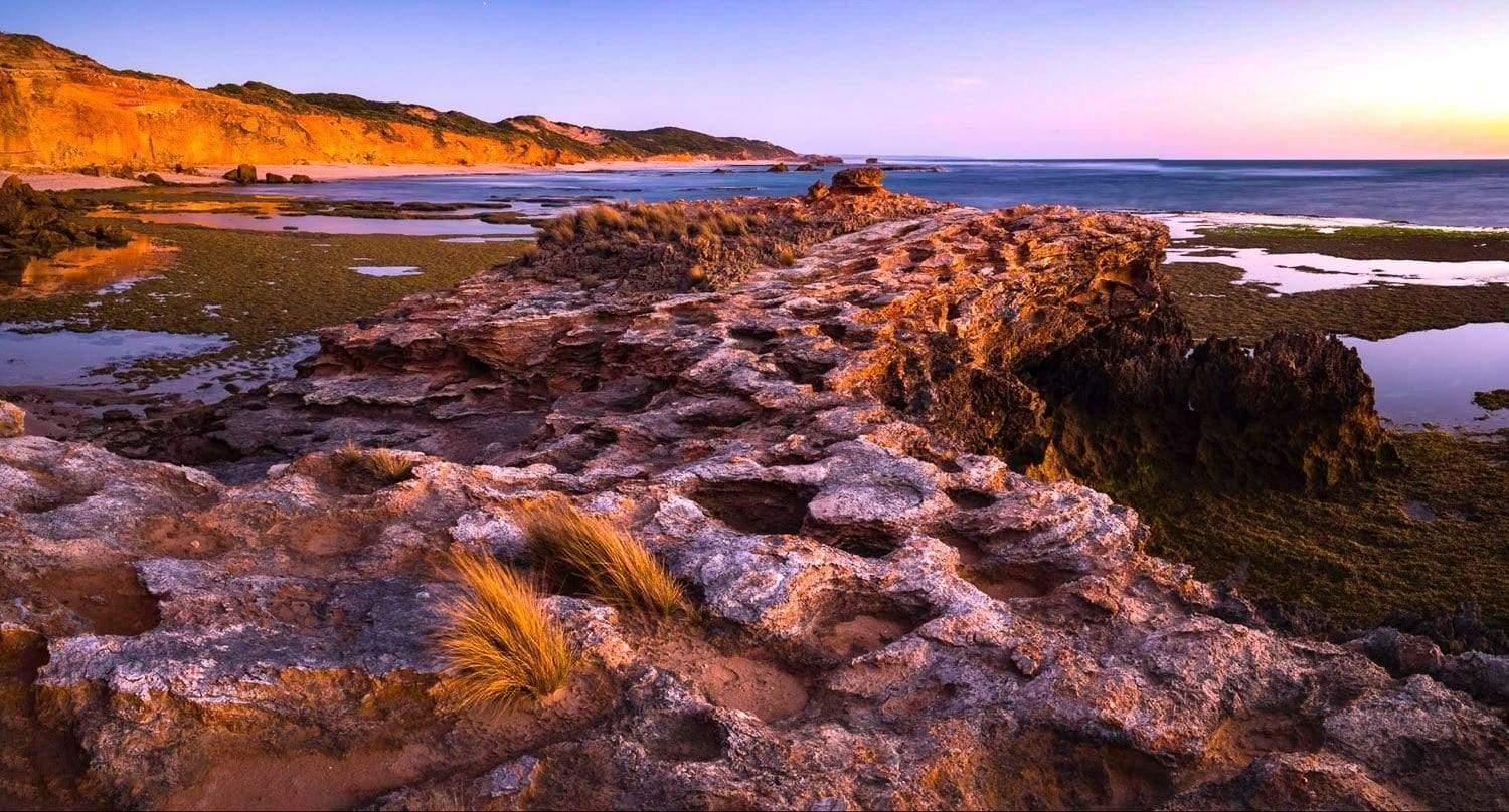 A stony land with different shapes of stones and along mountain wall in the background, Hidden Coast, Pt Nepean - Mornington Peninsula VIC 