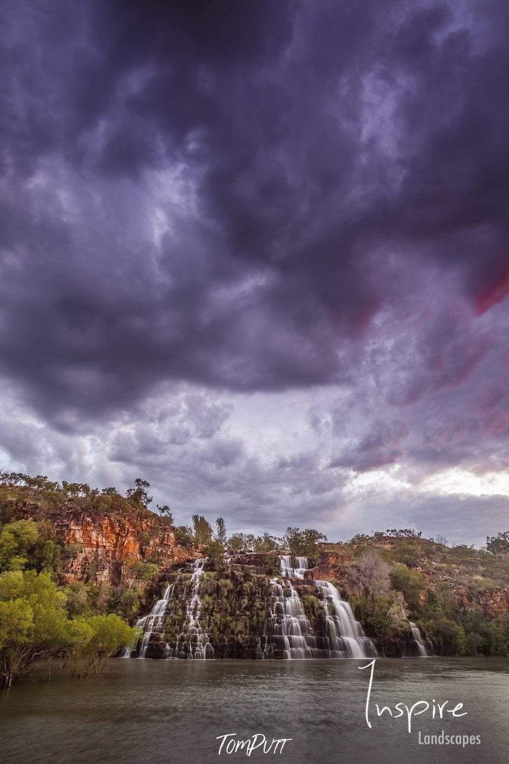A course of small waterfalls in the lack, with huge dense cloud over the scene, Kings Cascades - The Kimberley WA