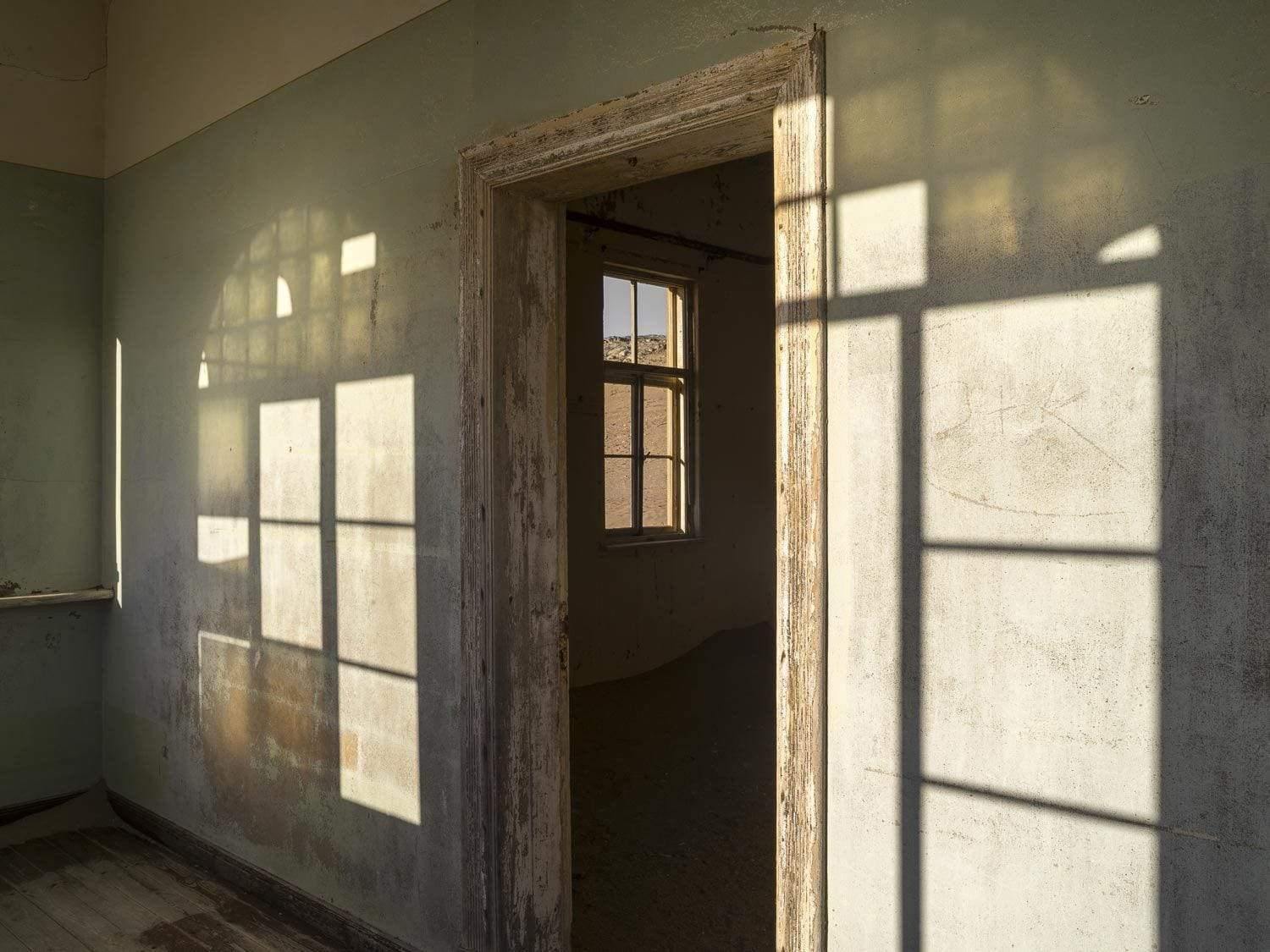 A wall with a door getting beautiful sunlight shadows, Kolmanskop #12