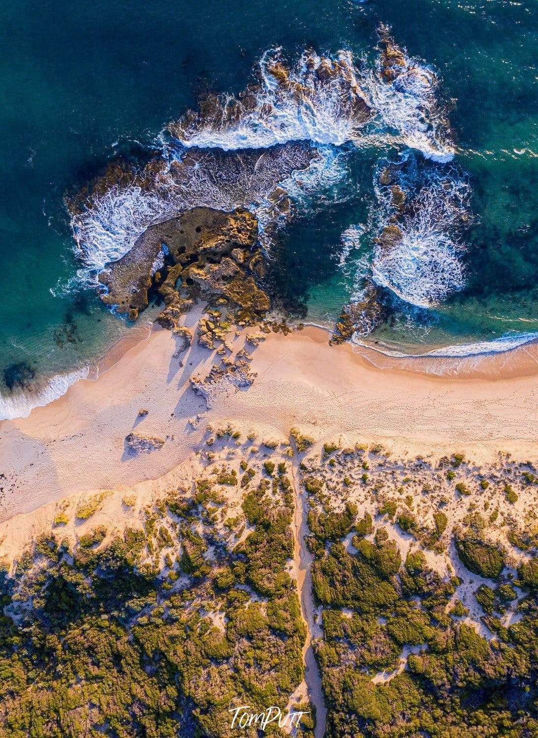 A great hill point with a lot of plants falling on a seashore with heavy bubbling waves, Koonya Beach Aerial, Sorrento - Mornington Peninsula VIC