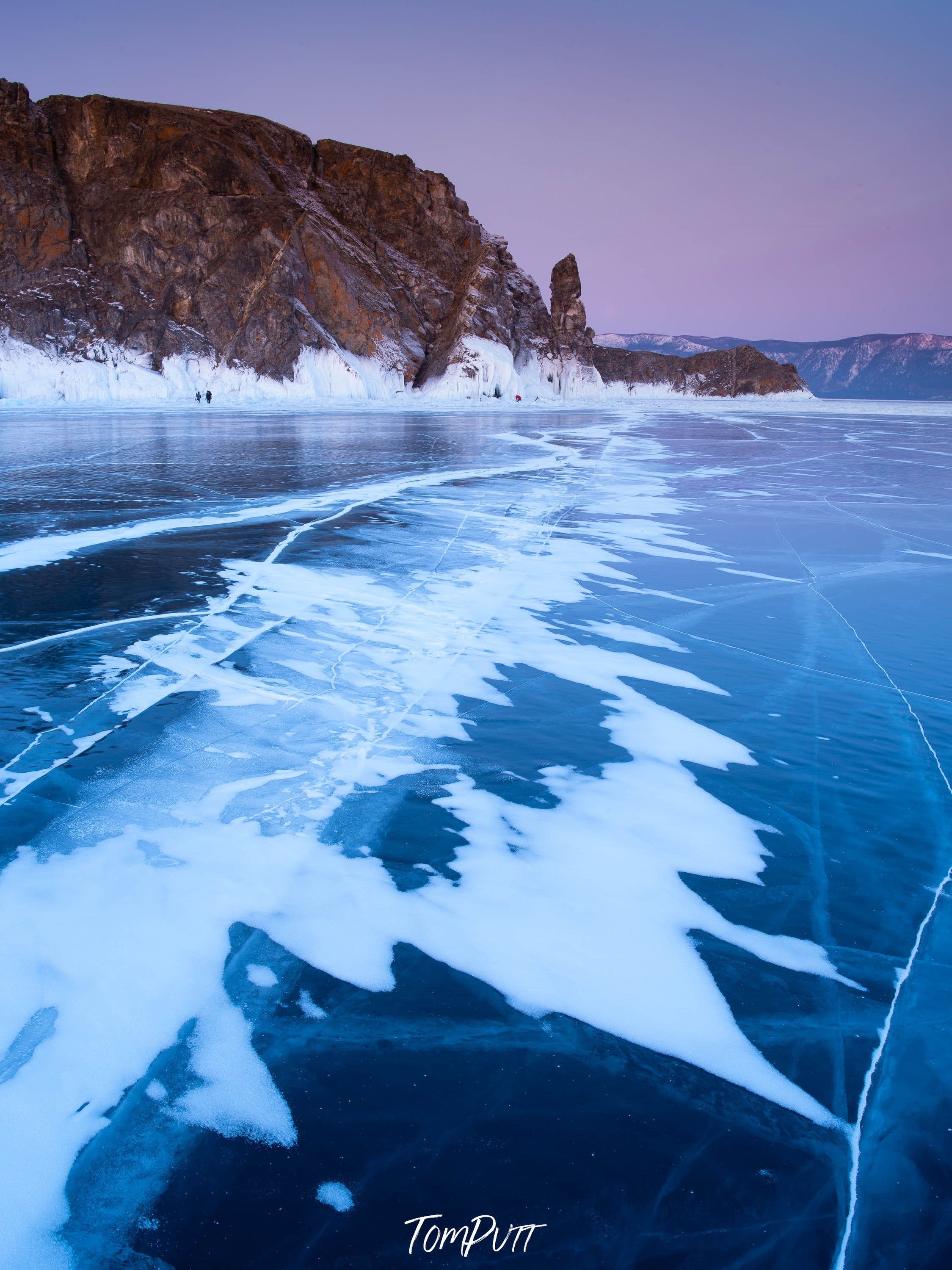 Frozen lake with a large black mountain in the background, Lake Baikal #1, Siberia, Russia