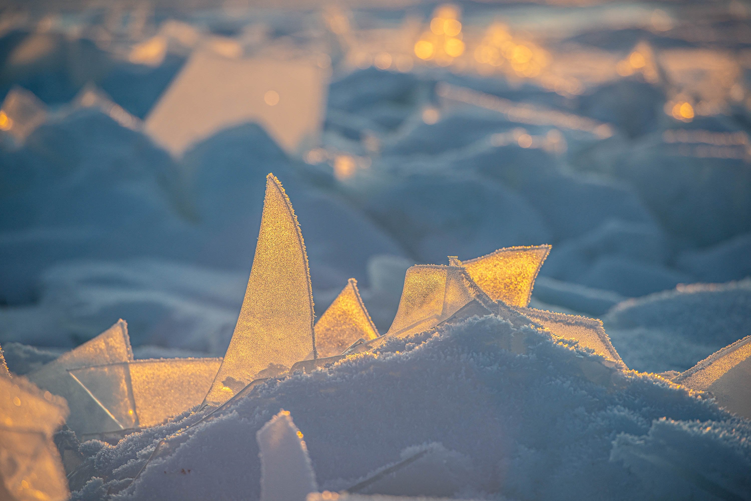 Close-up shot of sharp pieces of ice penetrating inside a soft snow mound, Lake Baikal #16, Siberia, Russia