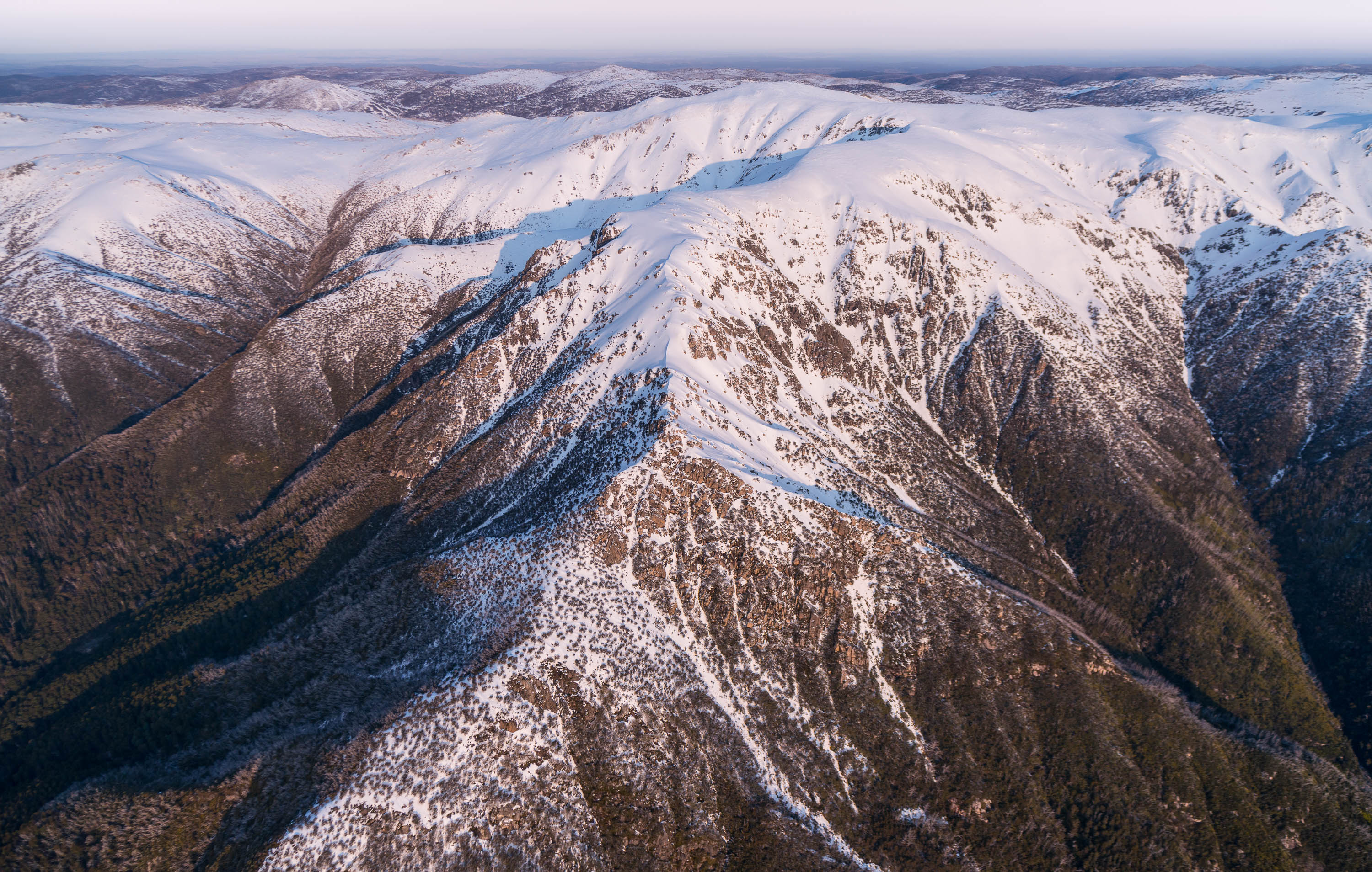 Large mountain walls with massive cracks and waves, Late Afternoon Light on the Western Face of the Snowy Mountains, New South Wales