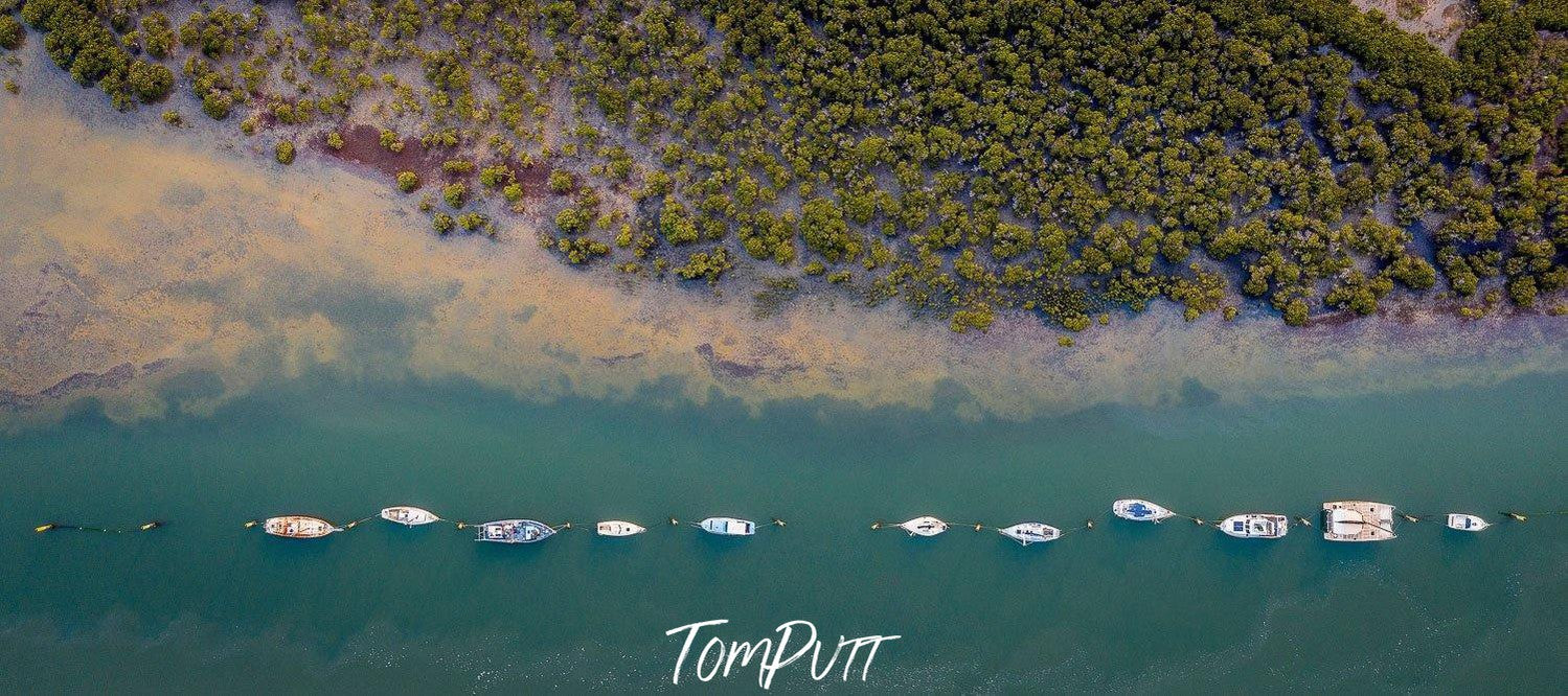 Aerial view of a beach with a line of many boats floating in a sequential manner, Lined Up, Warneet - Mornington Peninsula VIC