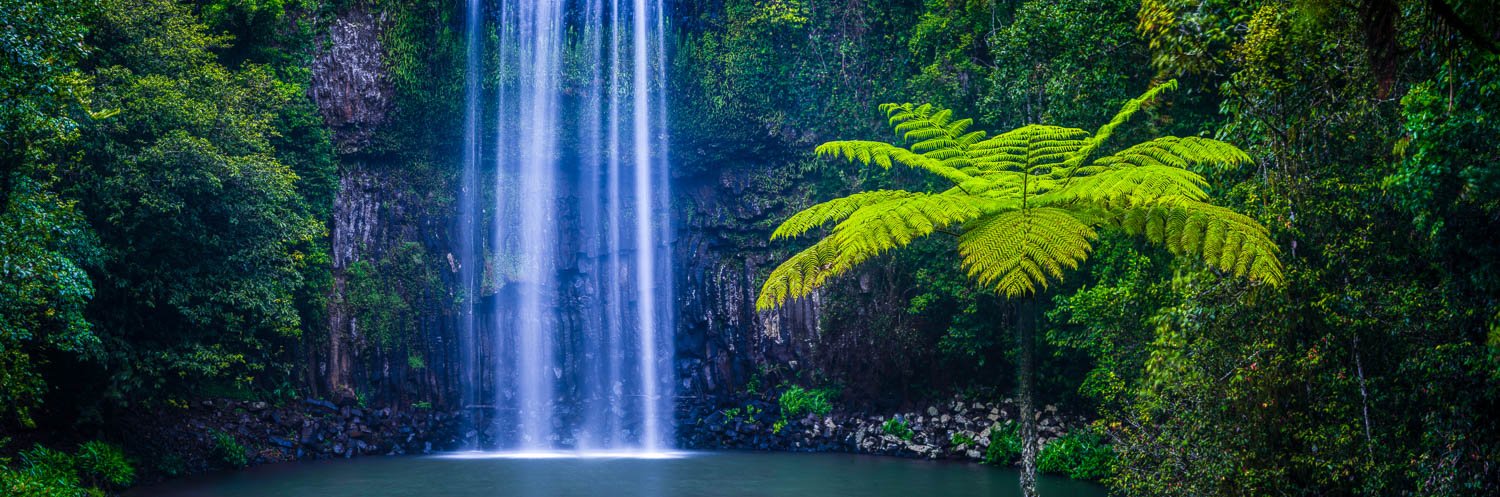 Waterfalls from green mountain walls in a small watercourse, Milla Milla Falls, Far North Queensland