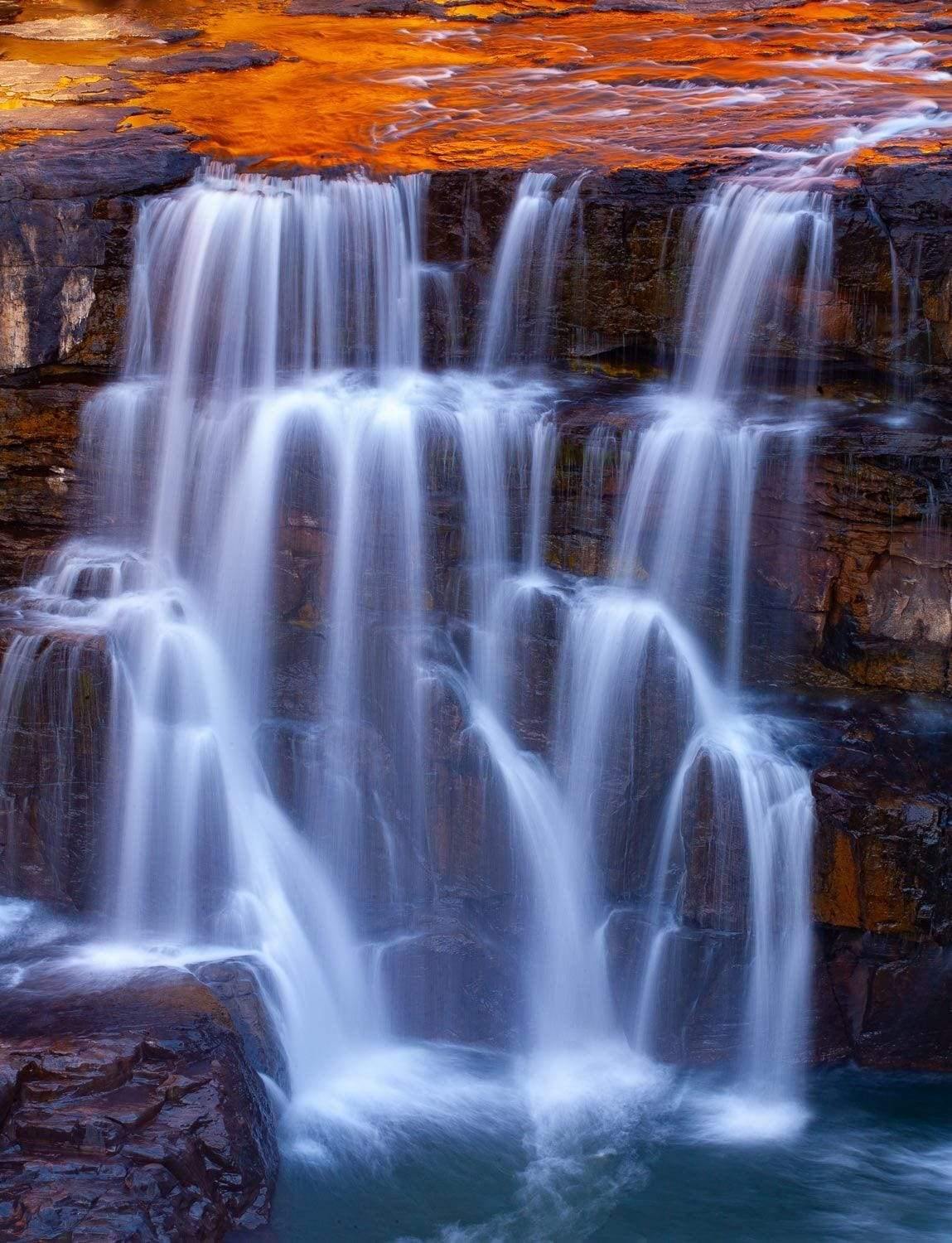 Wide waterfalls from a mountain wall into a lake, Mitchell Falls Cascades, The Kimberley, Western Australia