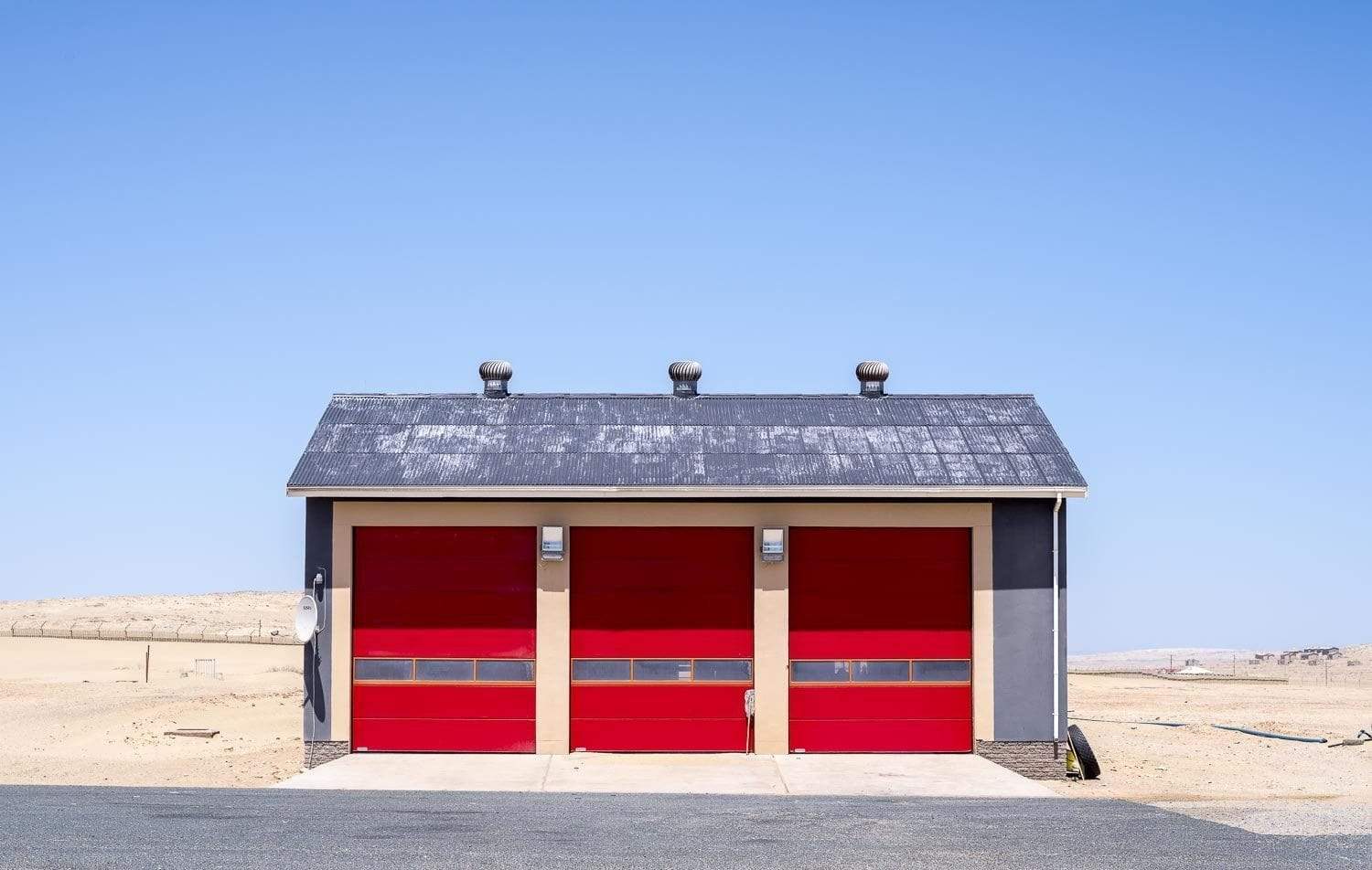 A small house with red walls and a black roof, in a desert area, Namibia #3