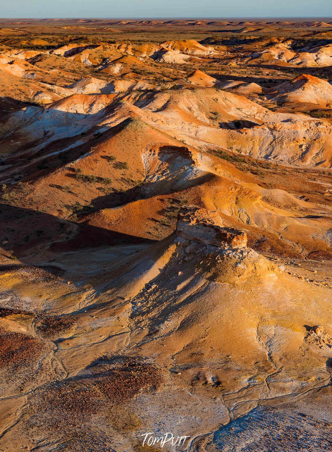 Aerial view of large golden mountains on desert land with sunlight fall, Painted Hills #16