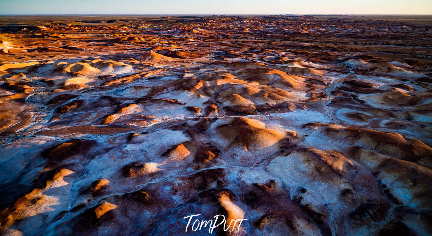 Aerial view of land with small mountains on the desert-like surface, and some powder-color sand over, Painted Hills #29