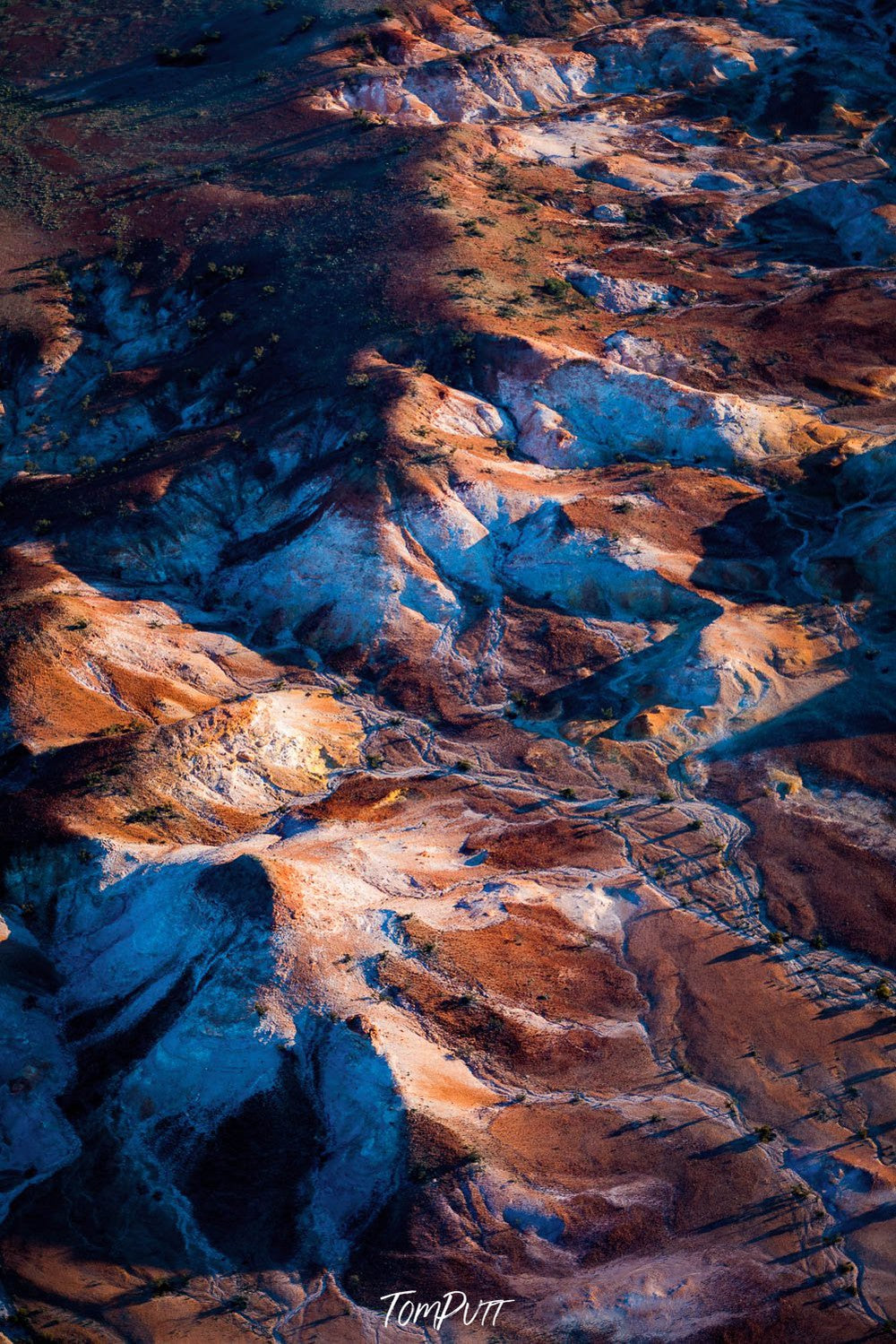 Aerial view of a painted snow mountains texture on a desert-like surface, partially under shadows, Painted Hills #24