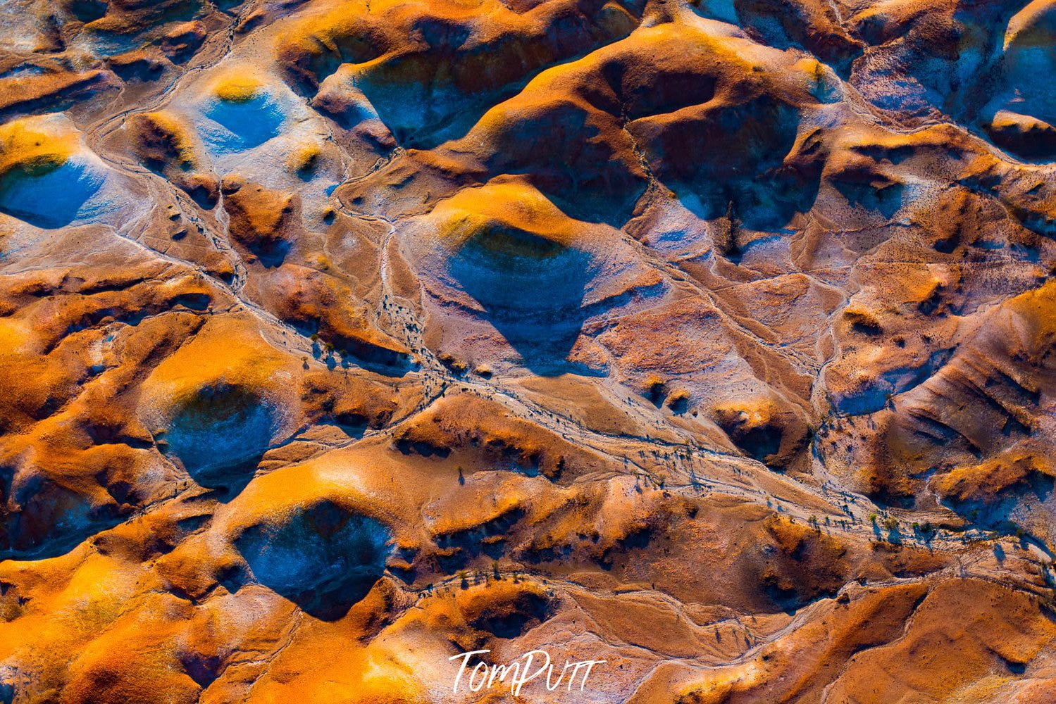 Aerial view of golden mounds on desert-like surface, with some snow on them, Painted Hills #28