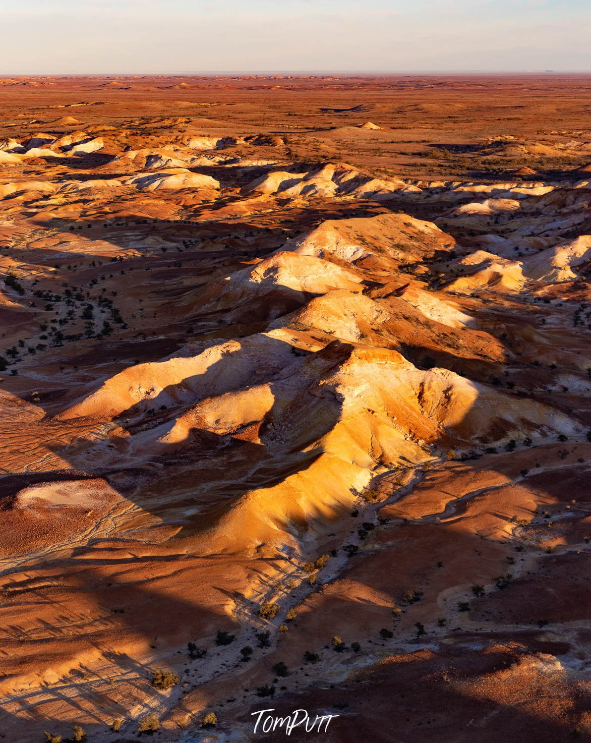 Aerial view of golden mountains on the desert-like surface, with partially hitting sunlight, Painted Hills #30