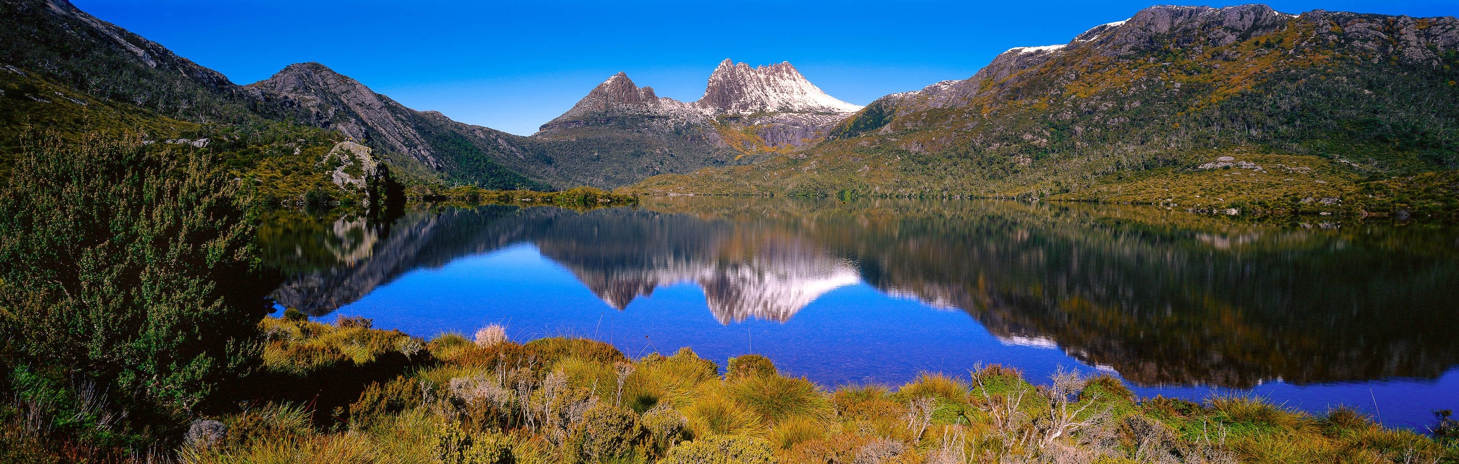 Beautiful mountain walls covered with green grass, and a lake in the center, Perfect Reflection, Cradle Mountain, Tasmania