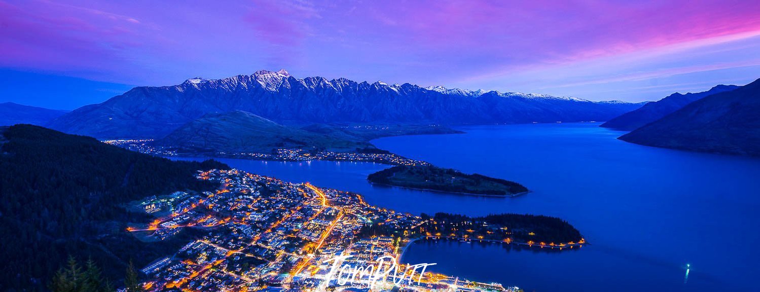 A small island city line with long mountain walls around, New Zealand #37