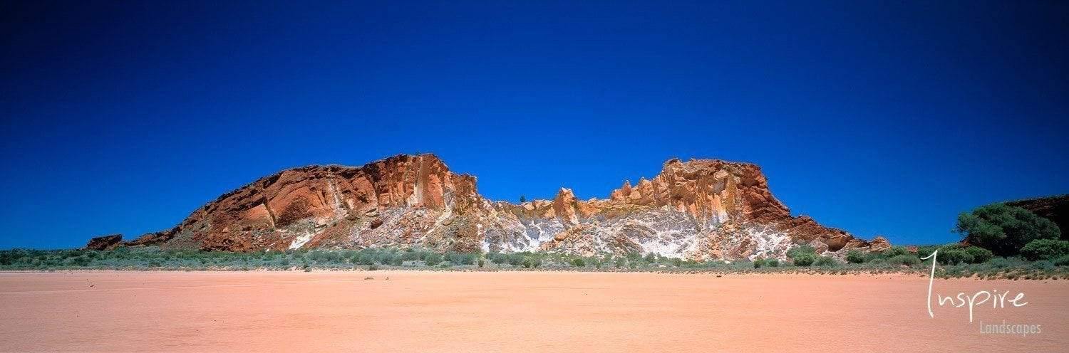 A couple of standing mountains on desert-like land, Rainbow Valley - Red Centre NT