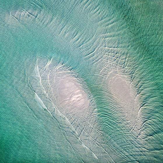 Aerial of a sea-green ocean with curvy water waves, Sand Bar - Mornington Peninsula VIC