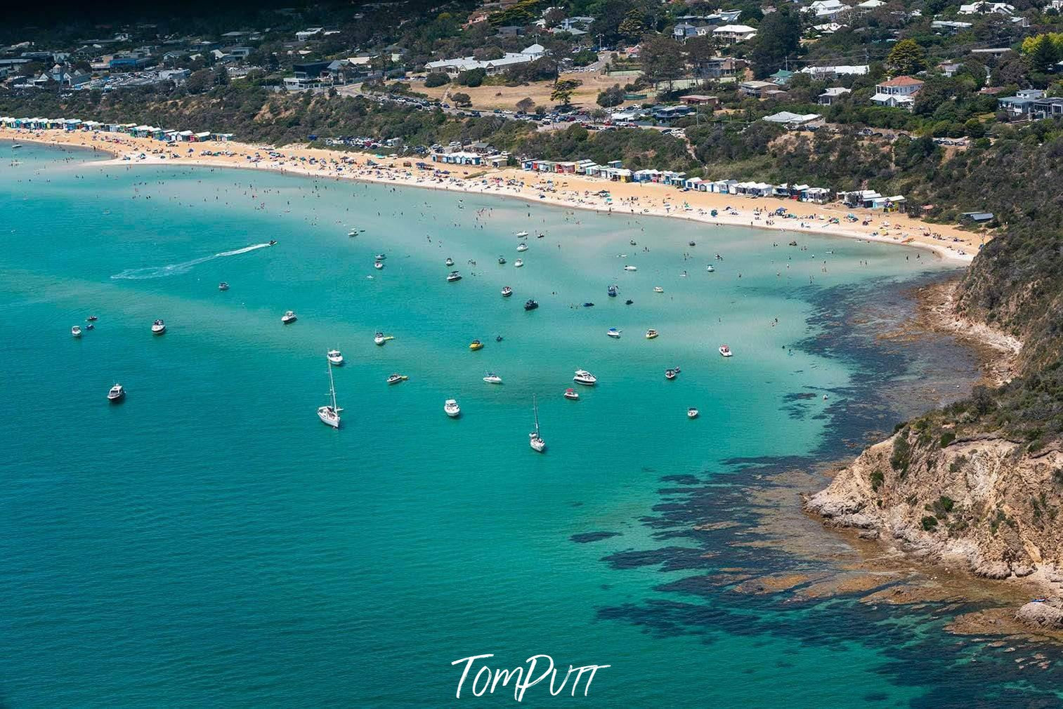 Long-shot of a busy beach with a lot of people and thick greenery above, South Beach, Mt Martha - Mornington Peninsula VIC