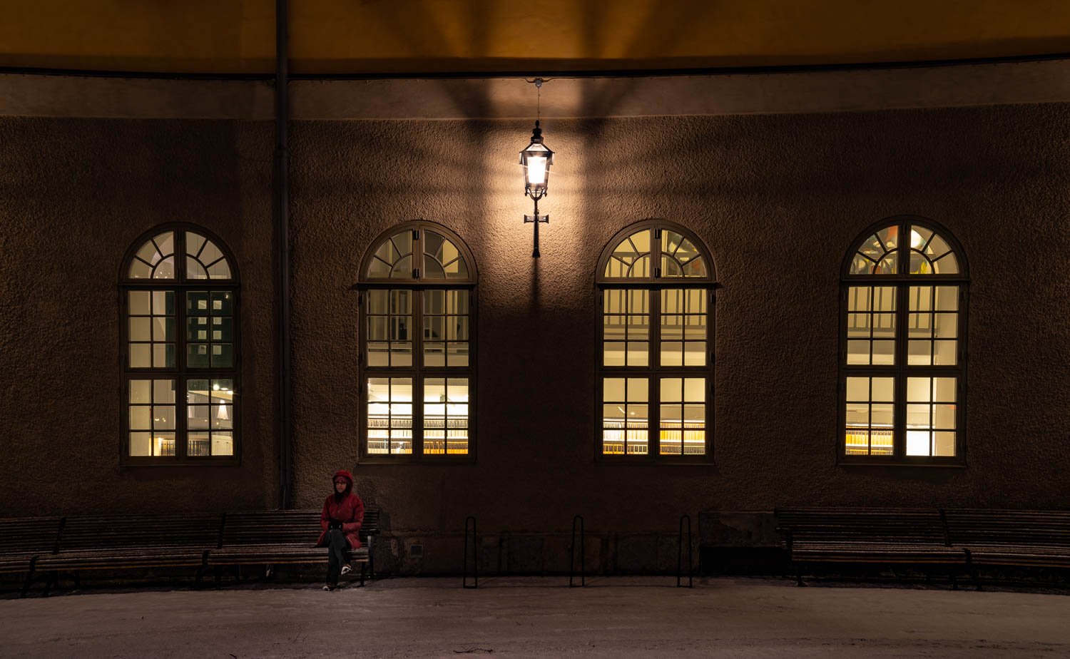 A shadowy capture of a big hall with a men sitting on a bench, Sweden 13