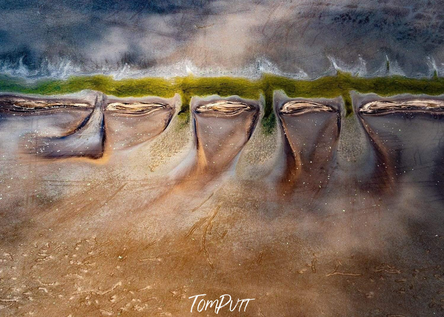 Aerial view of rocky land with some giant human teeth like pattern over, Wink