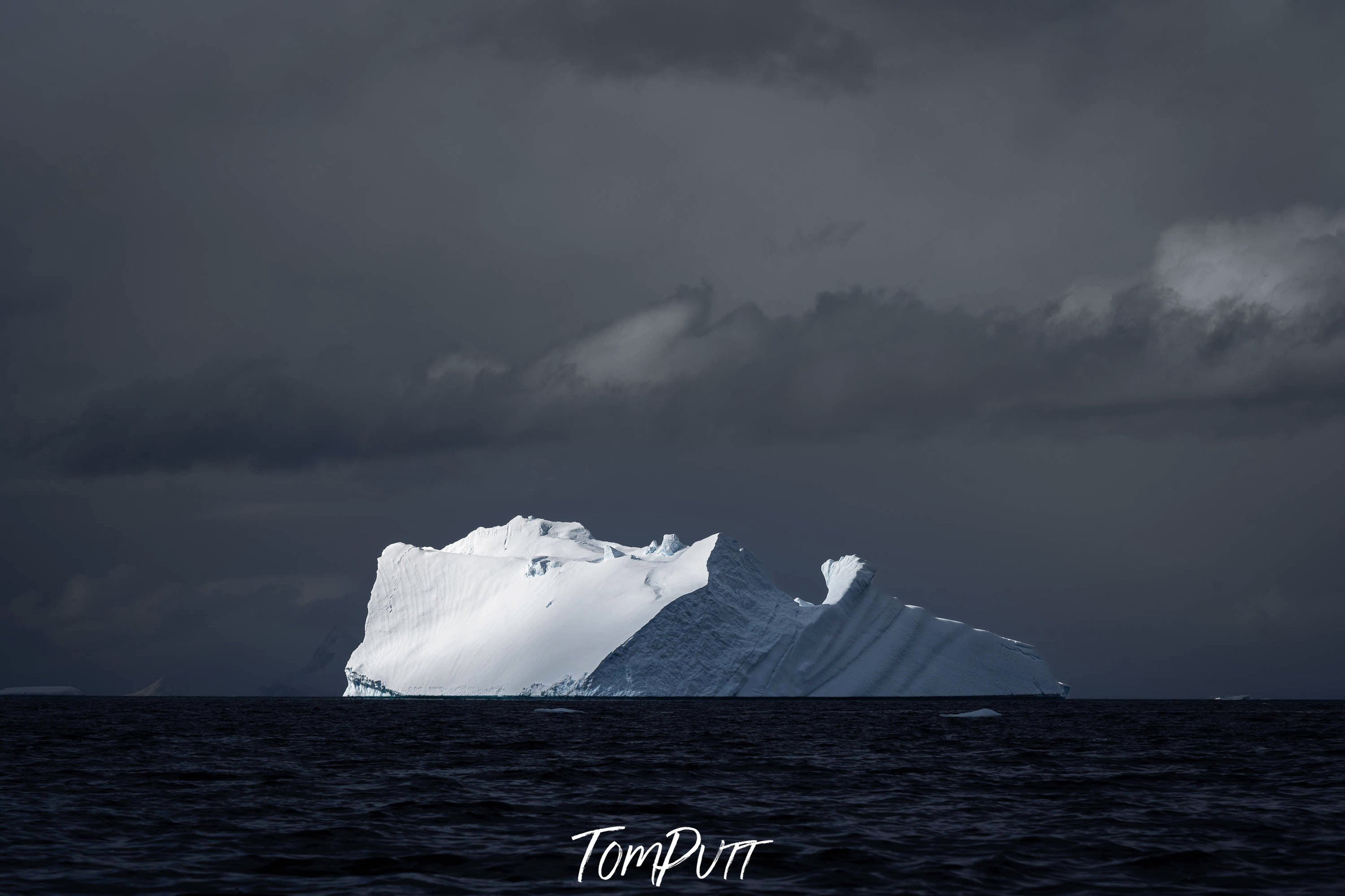 The Majestic Isolation of an Iceberg Amidst Stormy Seas