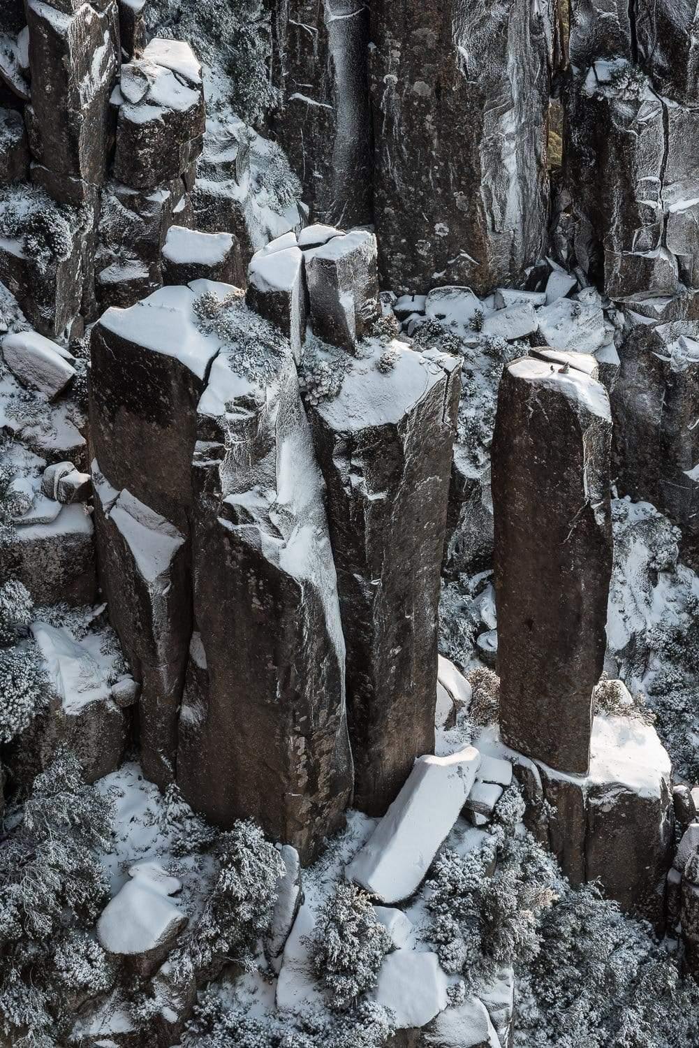 An undefined shape of standing pieces of giant stones penetrated in the ground, Amphitheatre Snowfall - MT Wellington