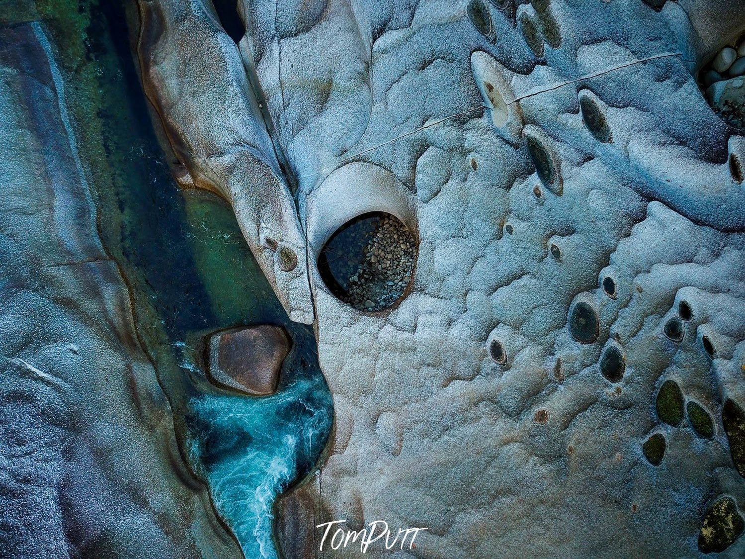 A weird texture of giant boulders having smoky and aqua colors, with some cracking texture on the surface, Babinda Boulders from above, Far North Queensland 