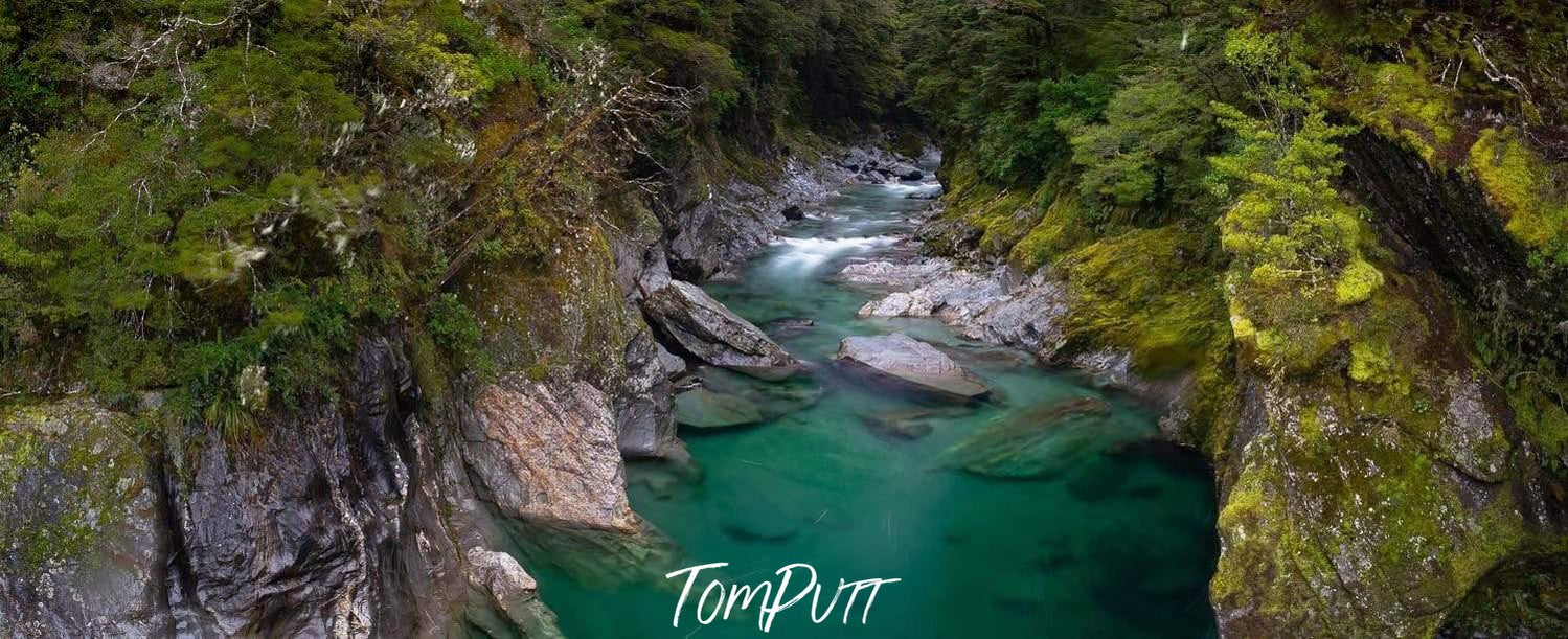 A beautiful landscape view from a hill of a lake with clear water, surrounded by high mountain walls with a lot of greenery on them, Blue Pools New Zealand Print Art