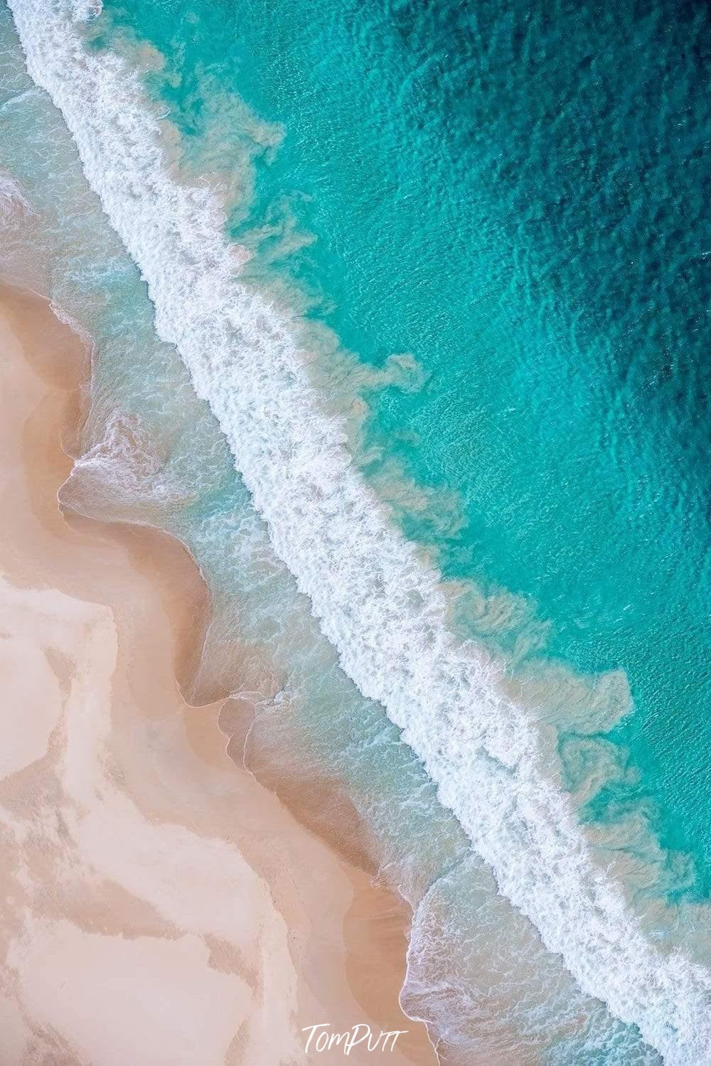 A seashore with heavy bubbling waves connecting with a desert-like land, Breaking Waves 