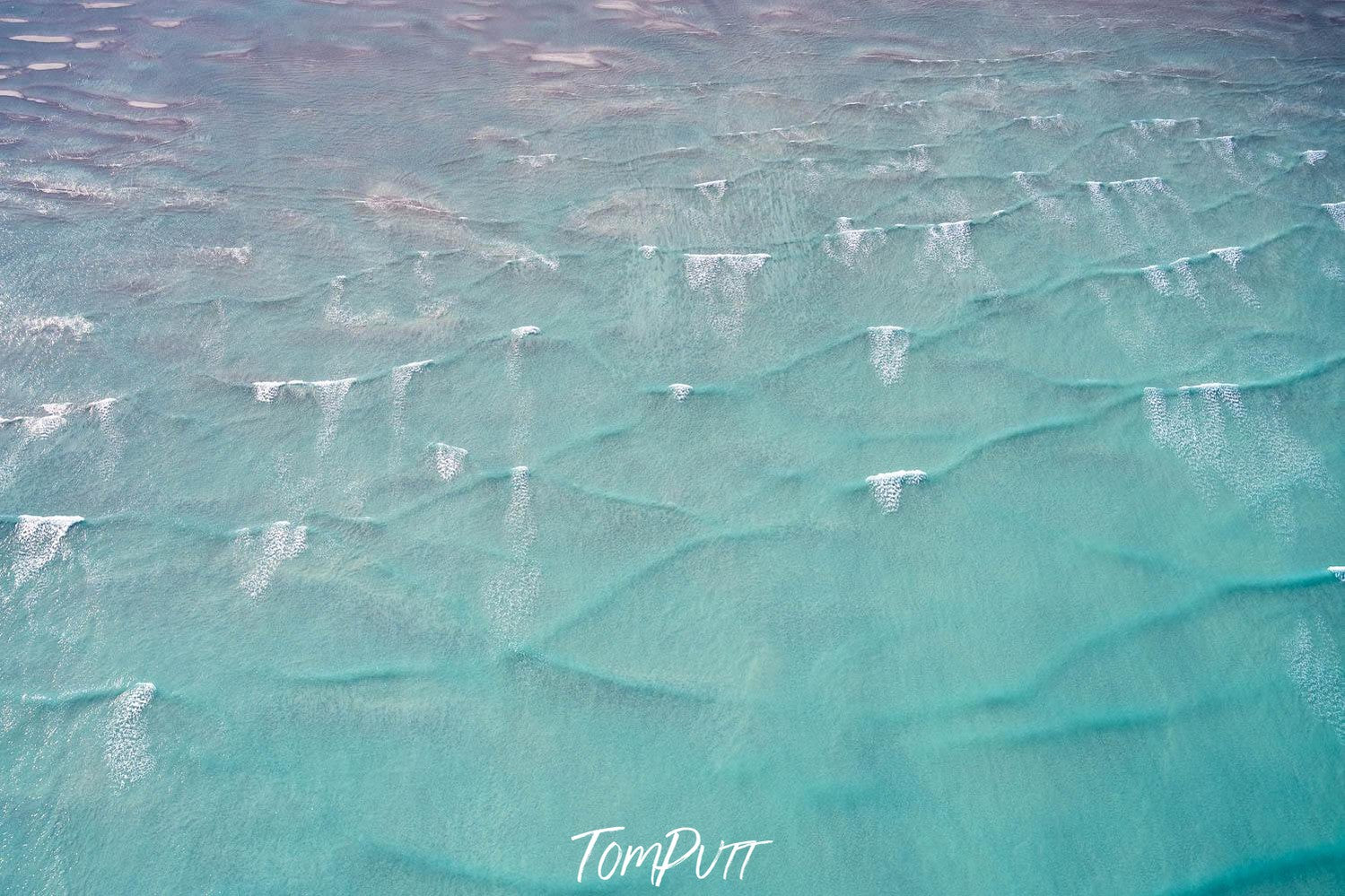 An oceanic area with some net-like texture underwater disturbing the steady flow of water, Broome No.18