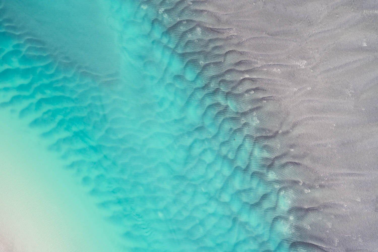 An unknown pattern of green-colored seashore making dispatching marks, and connecting with the wet dense sand, Broome #20