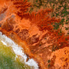 Aerial view of an orangish desert area connecting with the light green corner of the sea, Broome #49
