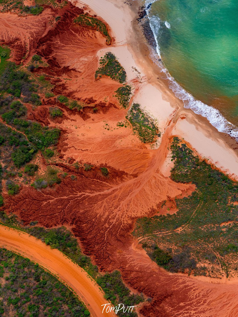 Aerial view of an orangish desert area connecting with the light green corner of the sea, Broome No.50