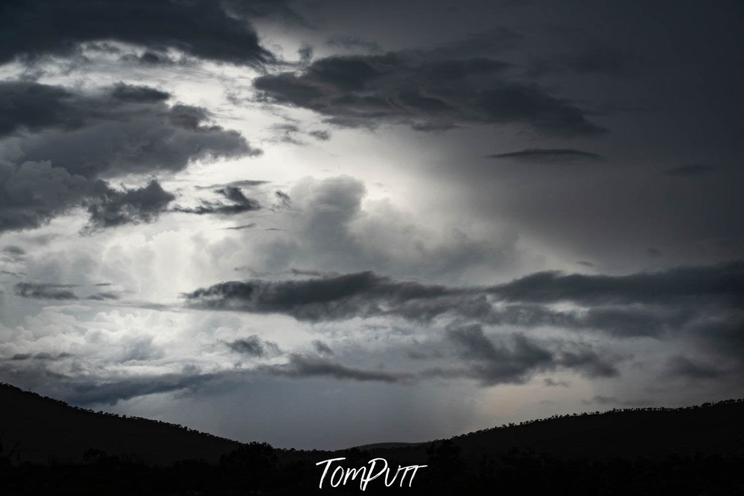 A group of dense black smoky clouds and a dark wall of mountain, captured from a hill point, Buildup - Karijini, The Pilbara