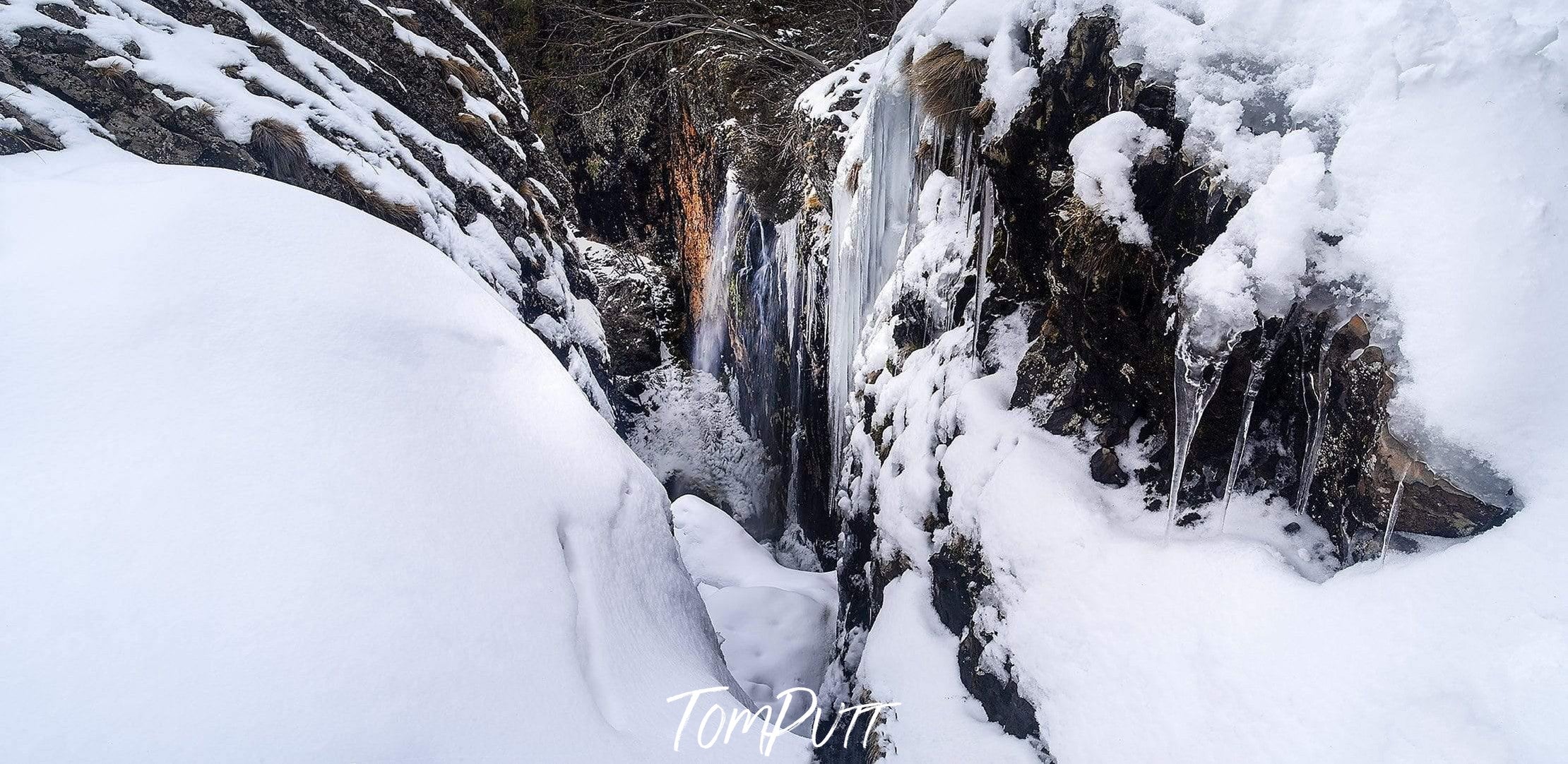 A narrow pathway between the walls of mountains covered fully with the fresh snow, Carmichael Falls - Dinner Plain