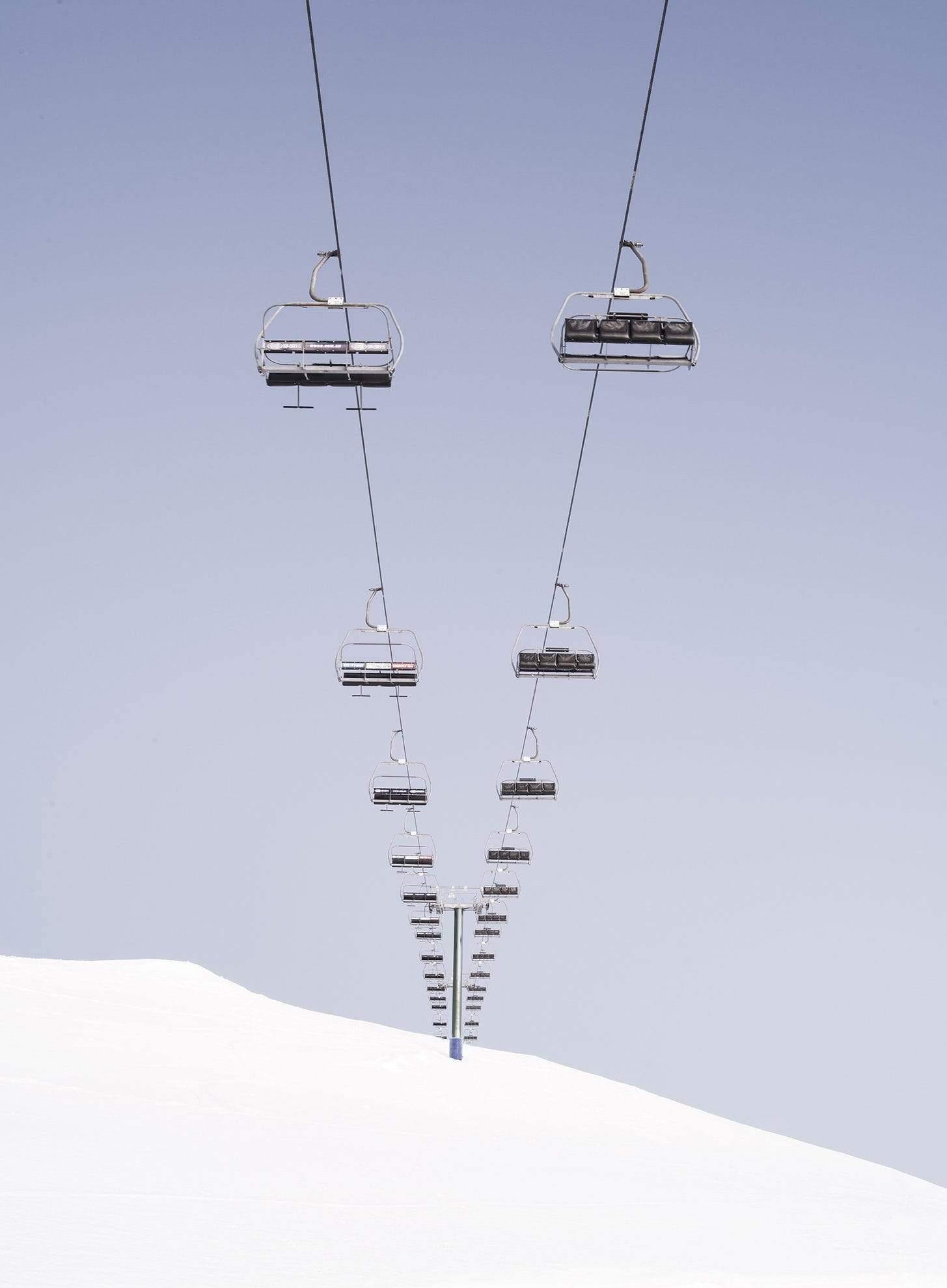 a beautiful view of a chairlifts series above the land fully covered with the fresh snow, Chairlift Mt Hotham, Victoria 