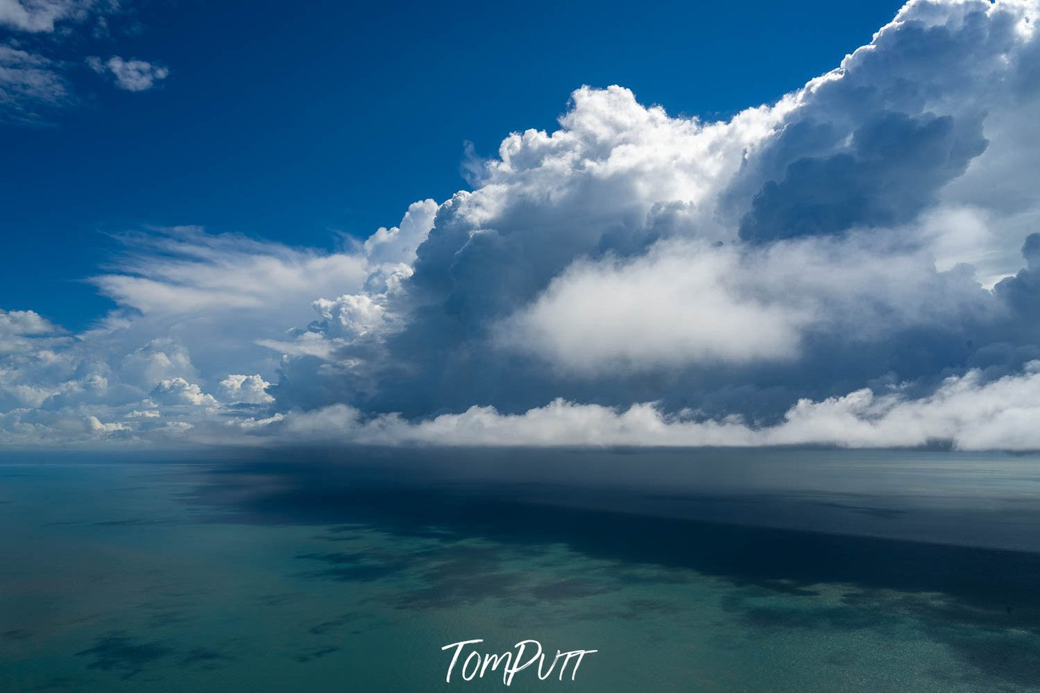 A giant smoky cloud just over the deep sea-green ocean stopping the shiny sunlight, Cloud Front, The Kimberley