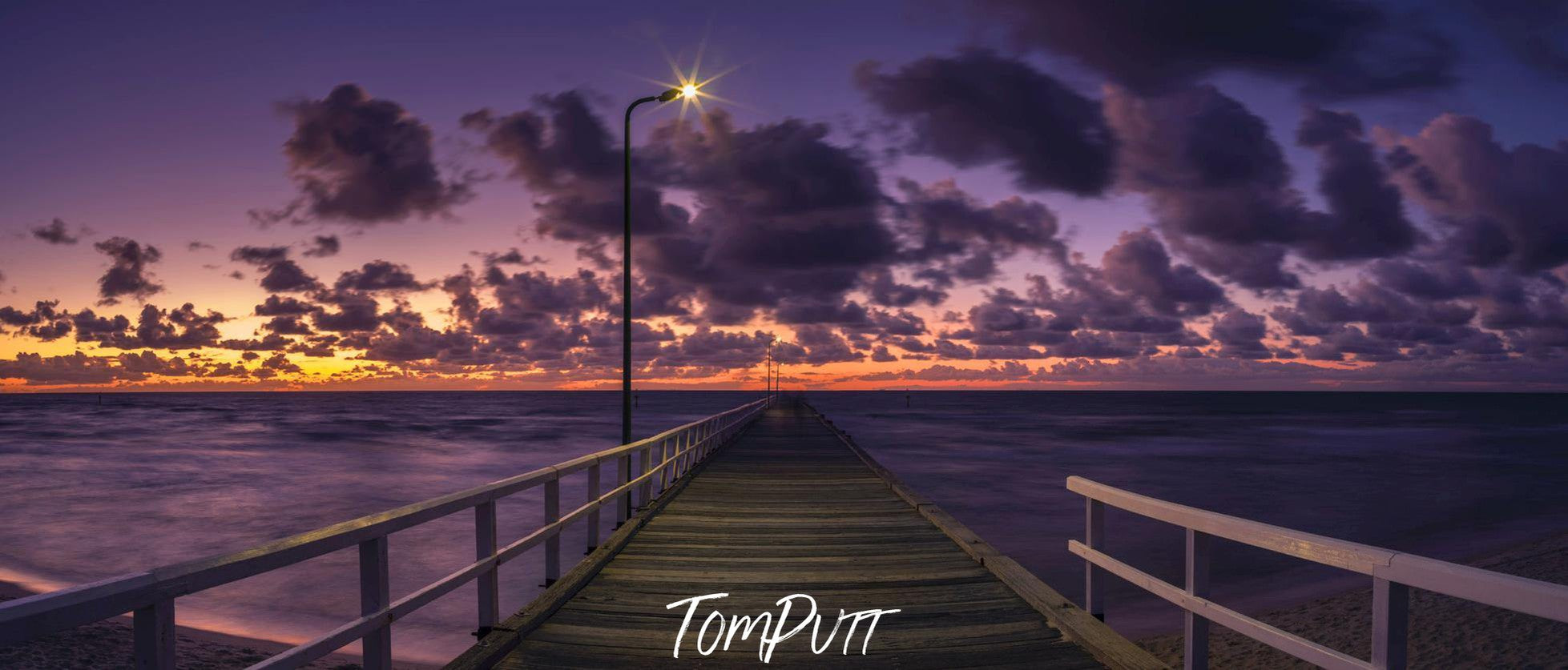 A beautiful wood bridge on the edge of the sea with silent surroundings and some dark thick clouds in the far background, Clouded Dusk, Seaford - Mornington Peninsula VIC