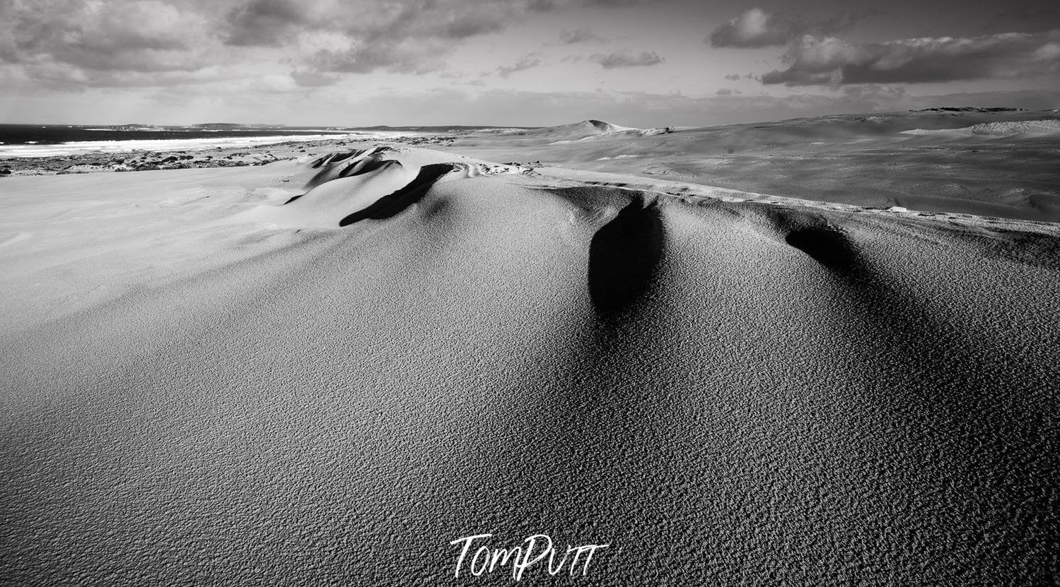 Naturally shaped sand with an upper corner and a static land behind it, a black and white-colored art, Coastal Sand Dune, Eyre Peninsula