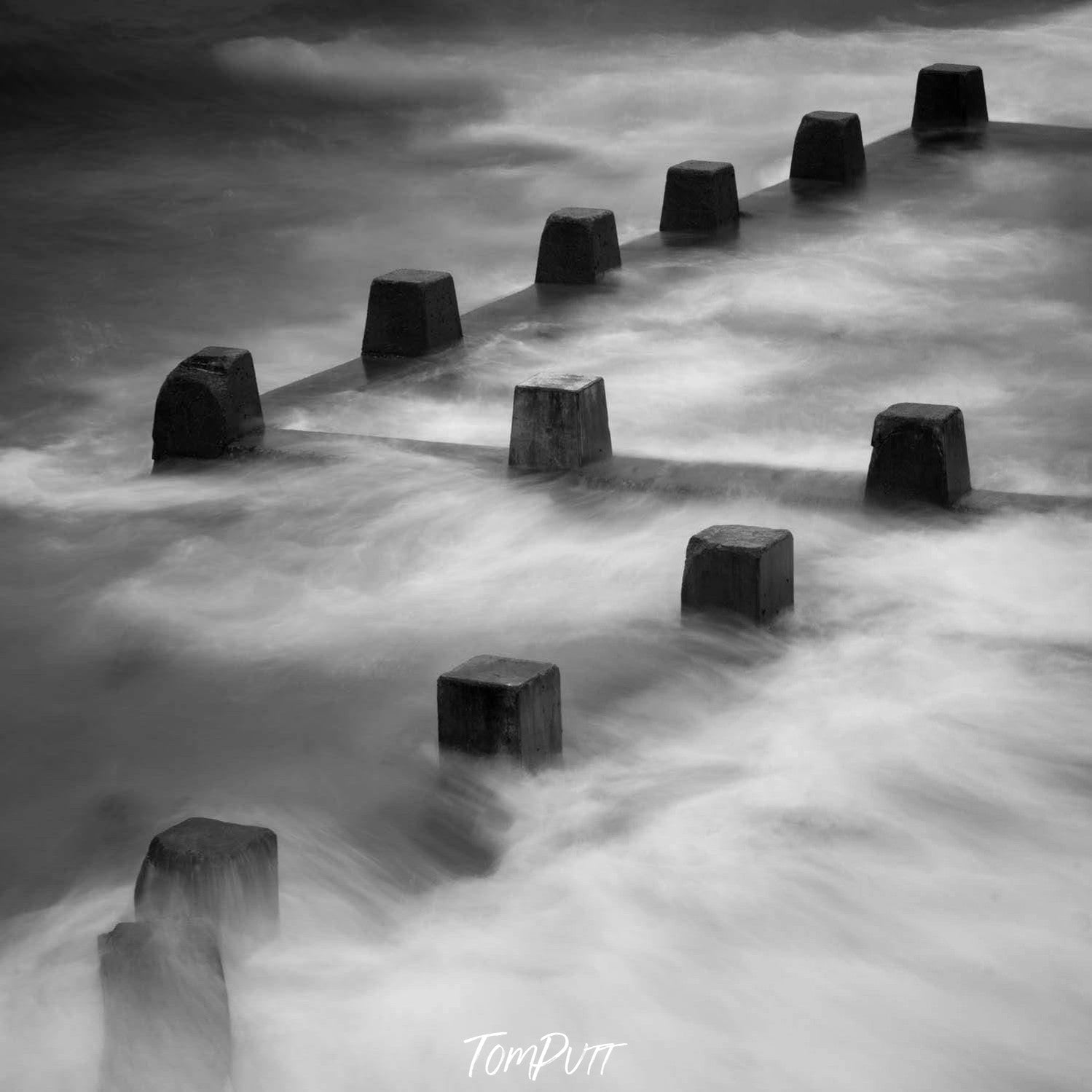 A weird parallel series of Stoney pillars standing tall with their top in the clouds, Coogee Pillars - Sydney New South Wales